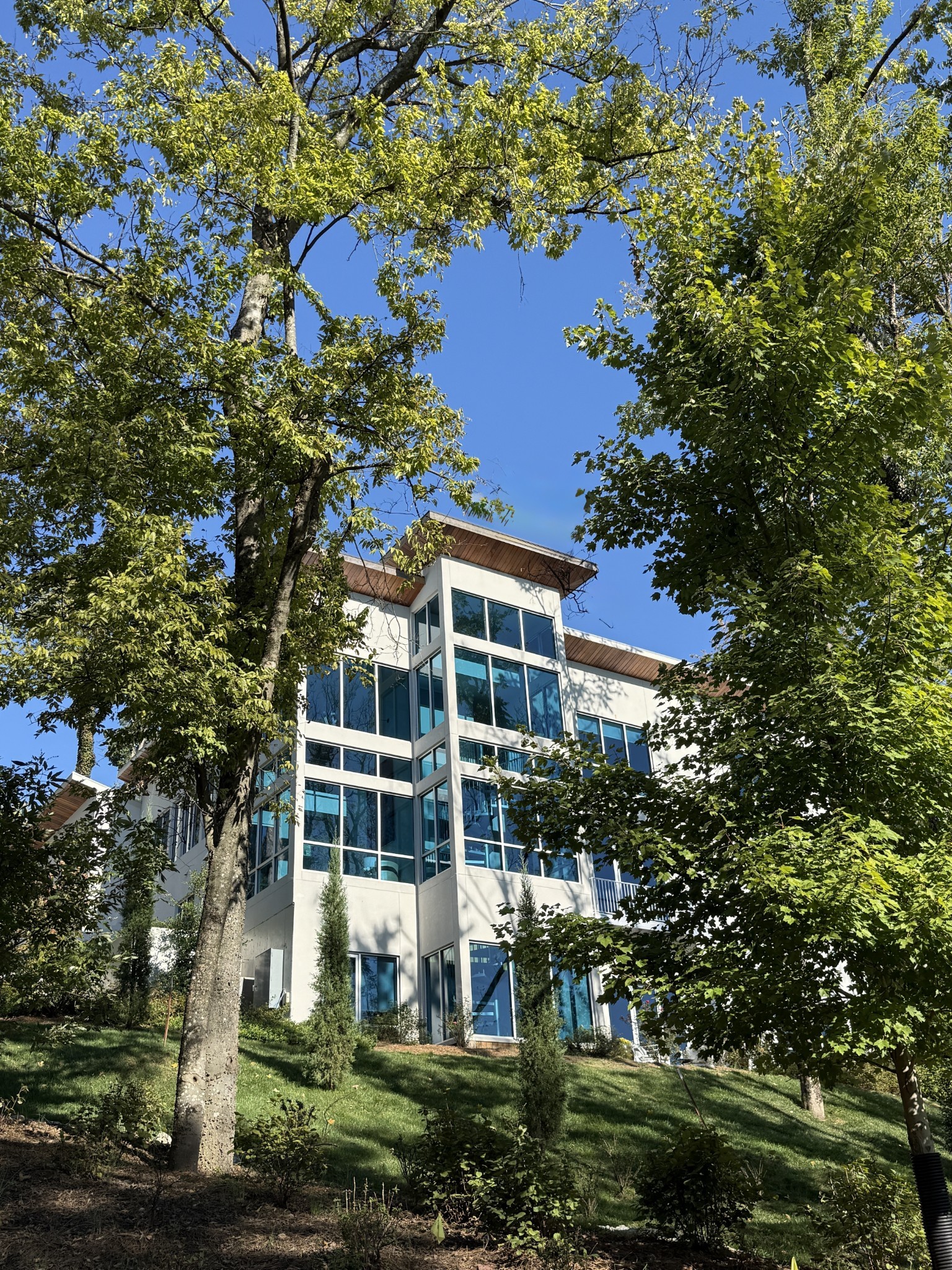 Set atop a lush private drive in one of Nashville’s most thoughtfully designed, beautifully landscaped communities, this home is ideal modern living where nature, luxury and convenience converge. Woodsong’s floor to ceiling windows offer unrivaled hilltop views of the stunning Tennessee foliage & sunsets. Location is paramount offering direct access to shopping, dining, health/wellness & numerous educational options. Between the neighborhood trail, nearby Radnor/Percy Parks & Richland Country Club, Voce borders the most desirable outdoor areas of Brentwood/Green Hills and is just 20+ minutes to the airport & all of Nashville. With a striking presence & impeccable craftsmanship, every detail of the home was curated with purpose. From the 1" windows, 2” countertops, transparent foyer & versatile spaces, no design element was overlooked. Whether you’re spending time in the family/entertainer's dream kitchen (dual sinks/dishwashers) or on the outdoor pool decks and patios, the options are effortless. Have multiple children or continual guests? Host various professional meetings? This home is designed for today's ever-evolving lifestyle. Enjoy the main level primary wing with dual baths or head to the upper/lower levels with four bedroom suites & a 6th bedroom w/ a powder room. Don’t miss the amazing office suite(s), upper/lower bonus rooms, inspiring glass gym, dual laundries & extra kitchenette. Additional highlights include an elevator, an EV charger, a driveway fit for 6 cars, abundant storage & a storm safe area. After the busyness of the day, life should be easy like 1701 Woodsong. Seller willing to provide standard stair replacement allowance or complete the standard stair install within 30 days post-close with acceptable offer.