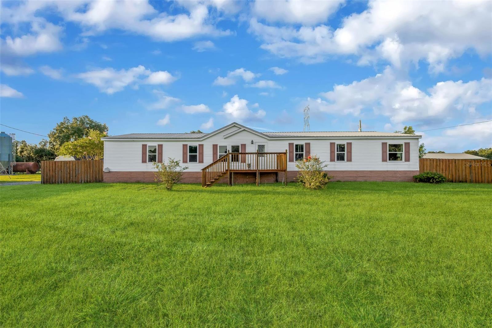 Experience the best of private country living on 2.56 acres in Plant City! Tucked away behind a fully fenced setting, this spacious 4-bedroom, 3-bathroom home offers approximately 2,432 square feet with an inviting open-concept layout designed for comfortable everyday living and entertaining. Each bedroom features its own walk-in closet, providing an abundance of storage and functionality. The beautifully refreshed kitchen is a standout, featuring a stylish shiplap-inspired backsplash, stainless steel appliances, generous cabinetry, and plenty of workspace for the home chef. The expansive primary suite offers a relaxing retreat with a garden tub, separate walk-in shower, and dual vanities. Outside is where this property truly shines. The acreage provides exceptional space and flexibility, complemented by a crushed-asphalt driveway and three substantial outbuildings: a 12x24 wood storage building with double barn doors, a 20x30 metal building, and an impressive 40x56 five-bay pole barn. Both the metal building and pole barn are equipped with water and electric, creating incredible potential for a workshop, equipment storage, hobbies, business use, or recreational needs. A 22-foot round above-ground pool with surrounding decking adds another dimension to the outdoor experience, perfect for cooling off and enjoying Florida's warm seasons. With NO HOA and NO CDD, this is the kind of property that offers space, privacy, versatility, and freedom—all while capturing the charm of authentic Plant City rural living. If you've been searching for acreage with room to spread out and plenty of possibilities, this exceptional property deserves a closer look!