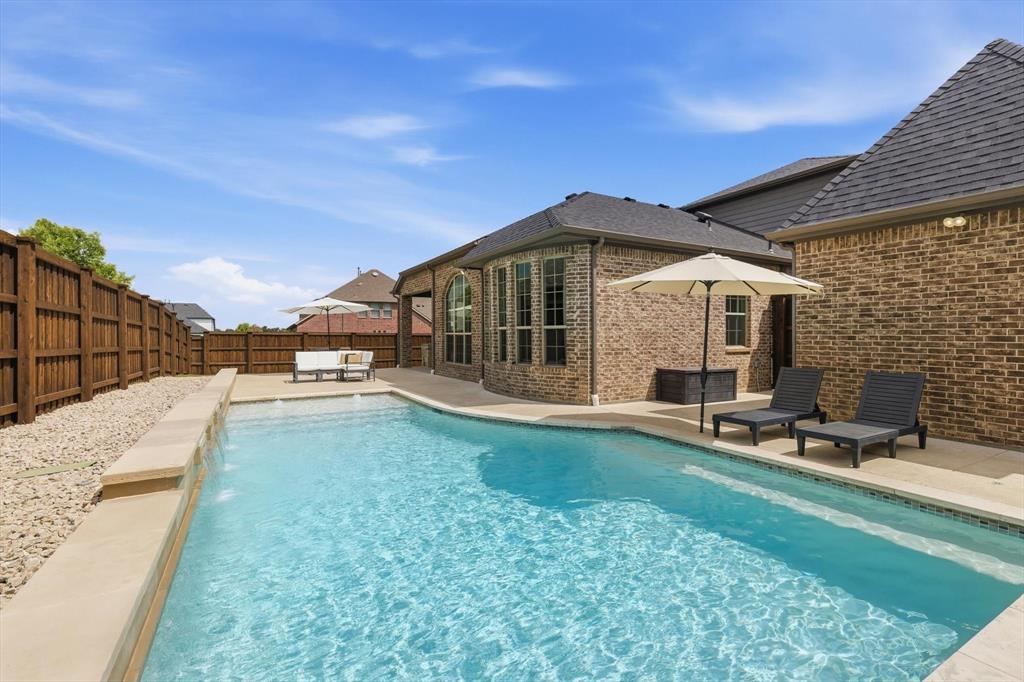Open For Showings This Weekend Only! Friday 12pm - Sunday 5pm. Open House SAT & SUN 12pm-2pm. Modern Smart Luxury Meets Resort-Style Living in Trophy Club, TX.Absolutely stunning 4-bedroom, 4 full bath Smart Home with a private in-law suite, perfectly positioned on a premium corner lot with a huge side yard—an ultra-rare combination. Step into your own private retreat featuring a heated pool with water falls, expansive entertaining space, and a fully equipped outdoor kitchen designed for unforgettable nights and year-round enjoyment. Thoughtfully upgraded with a new roof, extended privacy fence, and tons of space in attick for storage, this home delivers both style and peace of mind. The 3-car garage and seamless, move-in-ready design complete the package. Homes like this don’t come around often—luxury, space, and lifestyle all in one of the most saught after golf course communities in North Texas. Also named Safest City in Texas with Award Winning Schools.