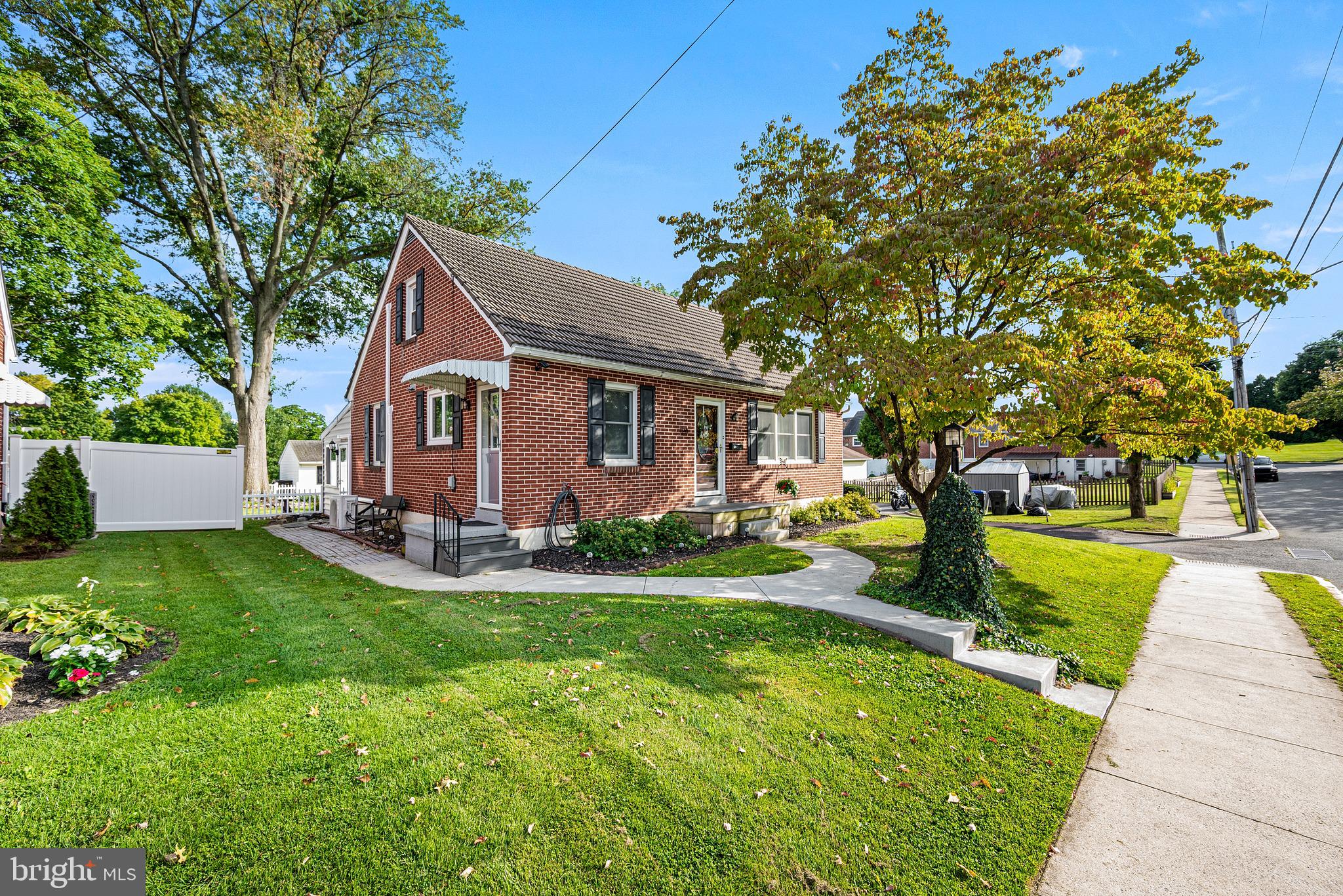 Located on a shaded side street in the heart of Boyertown, this attractive brick Cape Cod with curb appeal welcomes guests along a curved walkway leading to a wide entrance landing.   The inviting first floor features a large Living Room with exposed hardwood floors, open banister staircase, and plenty of windows; 25-handle Eat-In Kitchen with tile counters and tin-style backsplash; spacious Dining Room; and a beautiful and cheery sunken Sunroom with vaulted ceiling, tile flooring, and sliders to the back deck.  A Primary Bedroom with two closets, and a full ceramic tile Bathroom are also located on the ground level.  The second floor includes the 2nd and 3rd Bedrooms and lots of storage space.  A spacious lower level offers a finished Recreation Room plus a Utility Room with laundry facilities and an outside entrance.  There is plenty of room for hanging out on the back composite deck and patio areas; and for recreation in the awesome fenced backyard.  The oversized detached one-plus Car Garage offers extra space for projects plus there are 2 additional off street parking spots.  Central Air conditioning via multiple mini-split systems. Replacement windows.  Long-lasting masonry tile roofing. Low-maintenance exterior. Mature Landscaping.  0.19 +/- Acre Corner Lot.  The convenient location makes it easy to enjoy all that charming Boyertown has to offer: the historic State Theater, community library, unique stores, an exciting array of interesting restaurants, coffee shops, parks, and the ever-popular Colebrookdale Railroad tourism line.  Downtown events and fun activities draw the town and surrounding community together throughout the seasons.  Be sure to check out 124 S. Jefferson Street and see all that this great home has to offer.