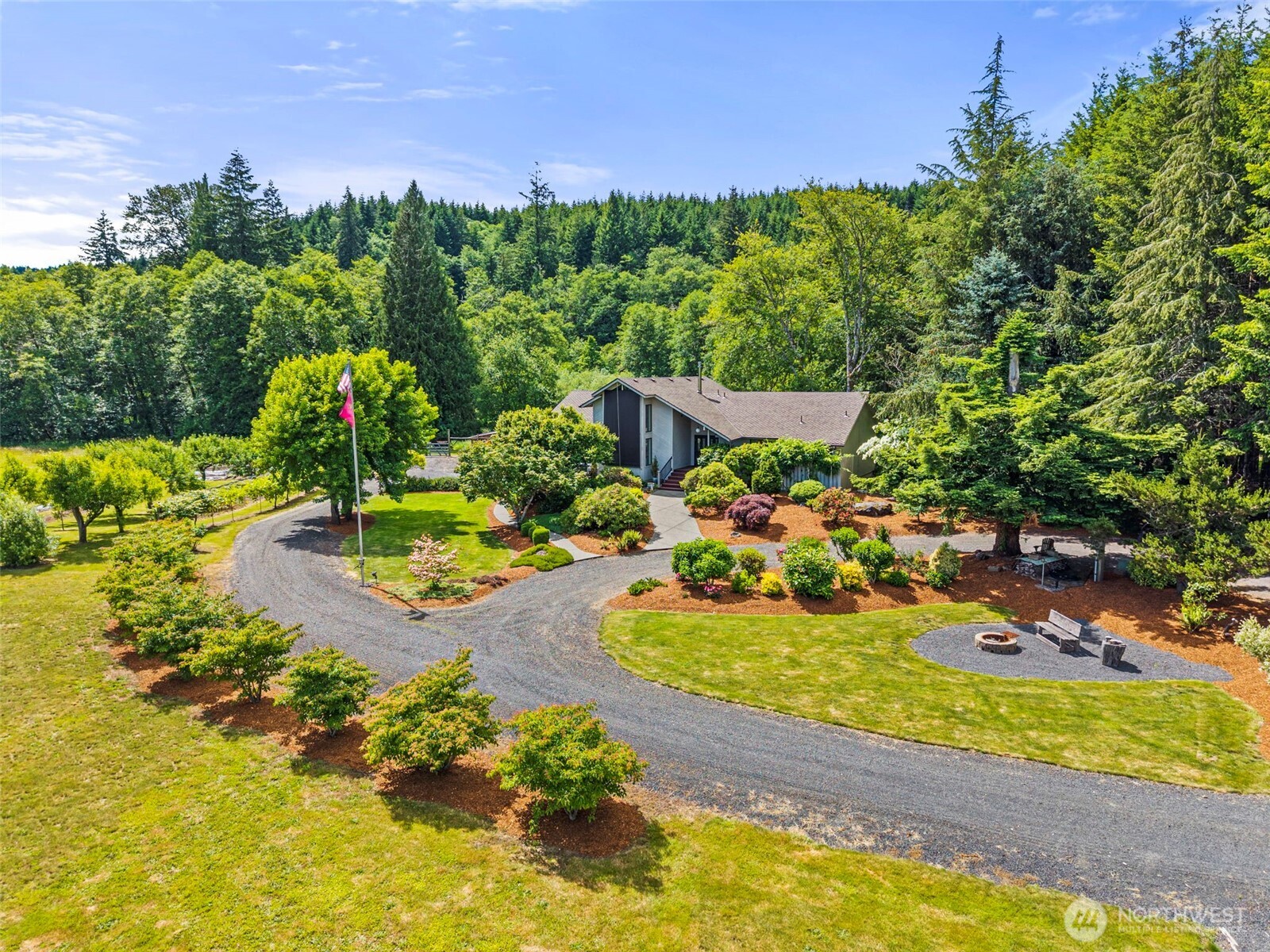 FIRST TIME EVER ON THE MARKET! Exceptional 2,700 +/- sq ft custom home situated on just over 7+/- fully fenced acres with low-bank river frontage and serene territorial views. Quality craftsmanship is showcased throughout with solid oak flooring, granite countertops, built-in vacuum system, and dramatic floor-to-ceiling cathedral windows that flood the home with natural light. The spacious loft provides additional flexibility, while the vaulted great room with propane stove creates a warm and inviting gathering space. Offering 3 bedrooms and 2.75 baths, the primary suite is a peaceful retreat featuring river views, a large soaking tub, and private access to its own deck. Power blinds, a retractable awning, and expansive composite decking provide exceptional spaces to relax and enjoy the surrounding beauty. The lush grounds are a gardener's delight with mature fruit trees, berry plants, grape vineyard, and room for animals or hobby farming. Outbuildings include a 24x36 barn, 26x55 machine shed, and an impressive 24x100 shop with attached greenhouse space, offering endless possibilities for projects, storage, equipment, and recreational pursuits. Rarely does a property combine quality improvements, exceptional outbuildings, usable acreage, and low-bank river access in such a picturesque setting. A truly remarkable offering and a rare opportunity to own a property making its market debut.