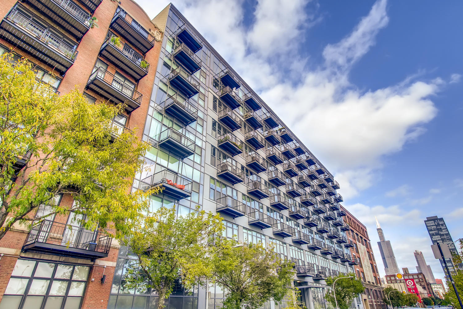 Welcome to the crown jewel of Van Buren Lofts, an expansive south facing 3 bed, 2 bath penthouse that stands as the largest floor plan in the building. Soaring 12-foot floor-to-ceiling windows flood the home with sunlight all day long, creating an airy, open feel that's both dramatic and inviting.  Enjoy two private balconies, ideal for morning coffee or sunset unwinding, with seamless indoor-outdoor flow from both the living space and the primary suite.  The updated chef's kitchen impresses with white cabinetry, sleek quartz countertops, a sprawling island with counter-height seating, tiled backsplash, modern hardware, and a pantry with custom shelving. The space flows into a generous living area anchored by a gas fireplace, perfect for hosting friends on crisp Chicago winter evenings or curling up by the fire on a cozy night in.  The enclosed king-sized primary suite offers a serene retreat, complete with a massive walk-in closet, dual vanities in the en-suite bath, and direct access to one of the home's two private balconies. The flexible layout includes a spacious enclosed second bedroom and a versatile third bedroom, deal for guests, a home office, or a fitness room.  Extras include: in-unit laundry, newer HVAC system. Step out onto your balcony and store away seasonal gear in the massive private storage room. Pull right into your deeded, heated garage parking spot which is priced at +25K. But who needs to drive in this highly walkable location with the West Loop as your personal backyard; offering endless opportunities to be soaked in culture, world class restaurants, bars, shops, parks, public transportation, Rush, UIC, I-290, I-94 and all in one of the city's most coveted school districts, Skinner!