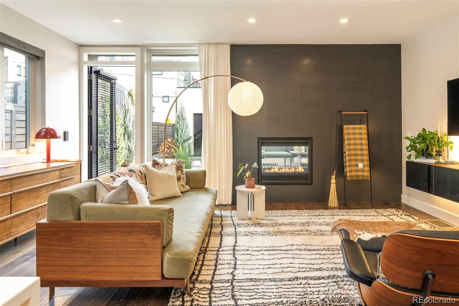 Welcome to this refined 4-bedroom townhome in the heart of Berkeley, ideally located at 4450 Utica Street, just one block from Tennyson Street and surrounded by Denver’s premier shopping, dining, parks, schools, and breweries. Thoughtfully upgraded with over $150,000 in improvements, this residence blends distinctive architectural details with modern comfort in one of Northwest Denver’s most walkable and desirable neighborhoods.The light-filled main level unfolds in an open-concept layout designed for both everyday living and effortless entertaining. Back deck features elevated hot tub and landscaped patio. Hardwood flooring runs throughout the home, anchoring the space with warmth and continuity. A west-facing office provides an ideal work-from-home setting, while the dining area flows seamlessly into the gourmet kitchen and living space. The kitchen features newer stainless steel appliances, quartz countertops, custom cabinetry, and connects to the living room through a striking see-through fireplace that opens to the private backyard patio, creating exceptional indoor-outdoor flow. Abundant natural light enhances the home’s welcoming and sophisticated atmosphere.The second level offers three well-appointed bedrooms, providing flexibility for primary living, guest accommodations, or additional workspace. Above it all, amazing third floor living area with pitched beam ceilings and a large rooftop deck with west-facing mountain views delivers an elevated outdoor retreat, ideal for entertaining, relaxing, or enjoying Colorado sunsets. With its premier Berkeley location, walkability to Tennyson Street, extensive upgrades, hardwood floors, seamless indoor-outdoor living, and rooftop deck with mountain views, this exceptional townhome offers a rare opportunity for elevated urban living in one of Denver’s most vibrant neighborhoods.