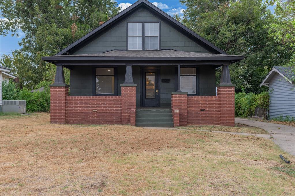 This adorable bungalow-style home delivers exceptional charm and functional living in an ideal Oklahoma City location. An inviting covered front porch welcomes you inside to beautifully refinished hardwood floors, bright natural light, and custom built-in shelving in the main living space. The main-floor primary suite sits right off the entry, boasting a fully remodeled en-suite bath with a custom tiled shower, brand-new vanity, and updated fixtures. Hosting is a breeze in the dedicated dining area framed by sunny bay windows, which flows into a completely updated kitchen featuring crisp painted cabinetry, sleek quartz countertops, tiled flooring, and brand-new appliances. A dedicated main-level laundry room and a second fully remodeled full bath add daily convenience down the hall. Upstairs, two versatile bedrooms flank a central flex space—ideal for a home office, hobby area, or extra storage. Complete with a detached two-car garage and a spacious backyard, this move-in-ready gem offers turn-key comfort and unbeatable appeal—reach out today to schedule your private tour!