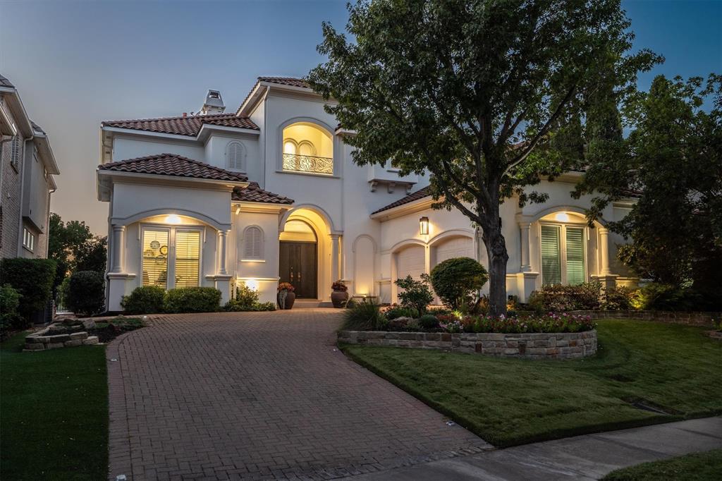 Experience refined Mediterranean-inspired living in this 4-bedroom, 4.5-bath custom home within the exclusive gated community of Fairway Vista in Las Colinas. Perfectly positioned on the 18th fairway of TPC Las Colinas, this residence offers a rare blend of sophistication, comfort & resort-style serenity. Designed with thoughtful flexibility, it features two primary suites—one on each level—ideal for guests or multi-generational living. From timeless architecture to panoramic golf course views, every detail reflects elegance & ease. Step inside the grand two-story entry, where a sweeping staircase sets the tone. Hardwood floors flow throughout, while automated window shades enhance light & privacy. A private office & formal dining room provide elegant spaces for work & entertaining. The rear of the home opens to a bright great room where soaring ceilings & walls of windows frame views of the sparkling pool & manicured fairway. The chef’s kitchen is a true centerpiece, featuring a generous island, built-in refrigerator, butler’s pantry with wine fridge, double ovens, refrigerator drawers & walk-in pantry. Upstairs, the owner’s retreat with spa-like bath is a private sanctuary with a sitting area that opens to the balcony for panoramic golf course views. Two additional bedrooms, each with ensuite baths, and a media room with wet bar complete the second floor. Outdoors, enjoy serene afternoons by the pool & spa as sunsets over the fairway create a setting of pure relaxation. This home blends resort-style living with refined everyday comfort—an exceptional opportunity in one of Las Colinas’ most coveted enclaves.