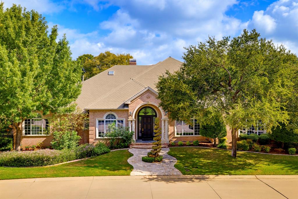 Nestled within the guarded and gated community of Mira Vista, this stunning traditional home offers an exceptional blend of timeless elegance, comfort, and resort-style living, overlooking the 15th green and 16th tee box with incredible golf course views. Featuring 4 bedrooms, 5 full bathrooms, a half bath, four spacious living areas, two dining areas, a dedicated office, and a three-car garage, this thoughtfully designed home offers plenty of room for everyday living, working, and entertaining. The upstairs flex space provides endless possibilities for a game room, or additional retreat, while the luxurious primary suite boasts a beautiful bathroom connected to a dedicated workout space. Step outside to an incredible backyard oasis complete with a sparkling pool, generous entertaining areas, mature trees, abundant shade, and a charming creek, creating a peaceful, private setting that feels like a retreat. With its picturesque golf course views, versatile living spaces, and exceptional outdoor amenities, this home offers a rare opportunity to enjoy the best of Mira Vista living.