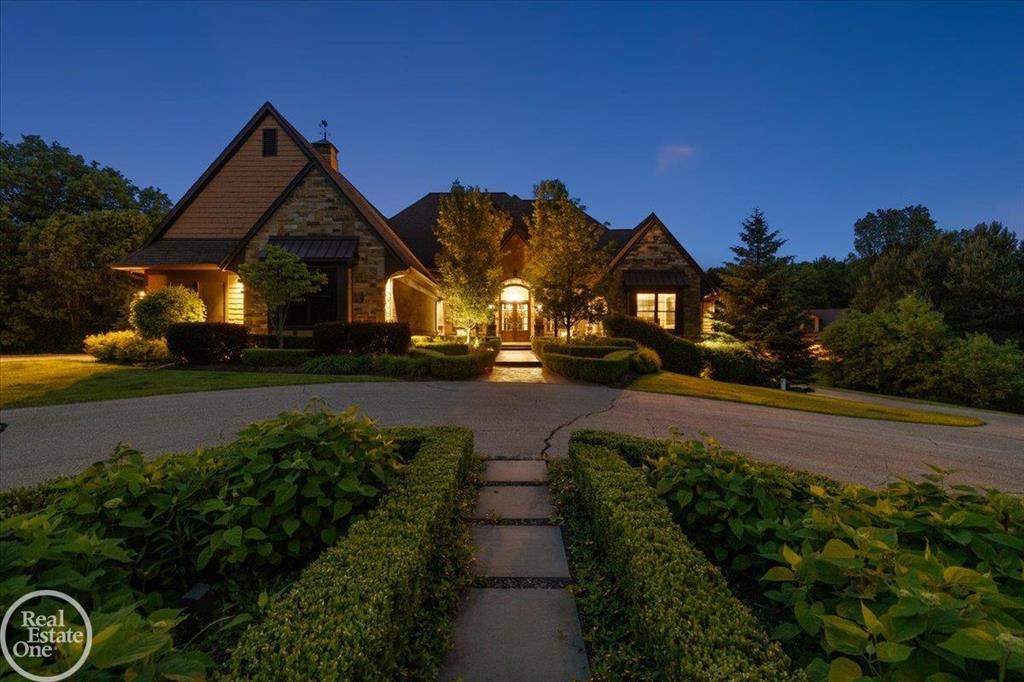 A Rare Find!! Private 31-acre gated estate in highly sought after Oakland Township.  This Estate features a custom built 1 1/2 story home with finished walkout to built-in swimming pool, 8,000 sq. ft. of finely appointed living area plus a 5,000 sq. ft. barn with awesome entertaining area including a wet bar, full kitchen, stone fireplace, open entertaining area with 2nd floor apartment plus additional parking for 10 cars; Gourmet chef's island kitchen with all commercial grade appliances, large hearth room & breakfast nook and wet bar; Beautiful hand rubbed beams and millwork in living room & formal dining area; Spacious primary suite with his & her walk-in closets with luxury bathroom; Finished walkout includes a 4th fireplace, open entertaining area with wet bar, exercise room and 4th full bathroom; Upper & lower covered patios with great views of well-manicured grounds, 36' x 18' in-ground swimming pool with hot tub; Trails through wooded acreage for the nature lover or outdoor enthusiast. Once in a lifetime property for those Buyer's looking to live in harmony with nature!! Property can be split.  Seller retains the right to exclude the 10-acres along Adams Road.