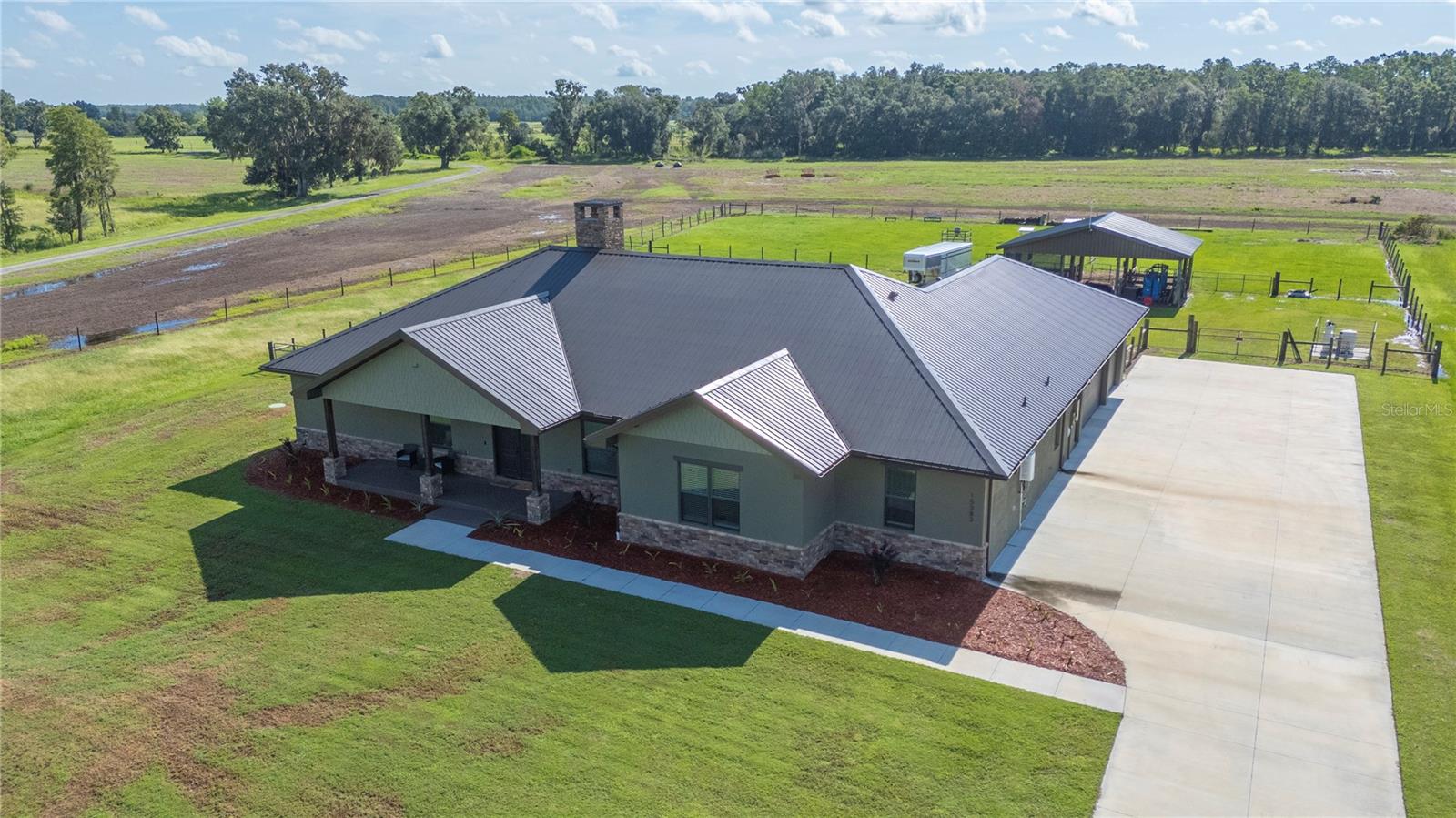 Welcome to this stunning 2023 custom-built home in gated North Lakeland, perfectly set on 1.68 acres. This 3-bedroom, 2.5-bath home offers 3,225 heated sq. ft. of open living space, plus a nursery/office off the primary suite and a versatile bonus room. Here, you’ll enjoy the perfect blend of country privacy and modern upgrades.Property Highlights:Barn & Livestock Ready: 12’x12’ stalls with automatic waterers/fans, storage stall for hay/equipment, and front/rear barn gates with a 10’ drive-through alley to pasture.Full-Home Backup Power: 24 KW Generac generator with 500-gallon propane tank (10–12 days of whole-house power).Spacious Interiors: Vaulted great room ceiling up to 17’, 10’ ceilings throughout, custom shelving in walk-in pantry.Chef’s Kitchen: Gas stove with convection oven, butcher block counters in pantry, oversized 4’x10’ island with storage and power, LED under/over cabinet lighting.Luxury Primary Suite: Nursery/office, dual sinks, garden tub, oversized 4’x8’ shower with bench and three shower heads, plus a large walk-in closet.Extra Features You’ll Love:Two A/C units for zoned comfort. 2 ton 16 SEER for the Master side of the home and a 5 ton 16 SEER unit for the remainder of the homeWalk-through attic storage accessible from master closet and garage — you can walk the length of the homeCustom 5.5-foot block masonry wood-burning fireplaceDog wash/mudroom shower in laundry roomSite-built trusses for hurricane durabilityTwo tankless gas water heatersCovered screened porch with quick-connect propane for grilling or gas fireplaceOutdoor Living & Curb Appeal:Seamless gutters, Govee Pro LED soffit lighting, and room for gardening, recreation, or animal enclosures. Long paved driveway and 3-car garage for vehicles, equipment, or toys. Private well and septic system.This property offers the space, functionality, and upscale finishes buyers want—without sacrificing the charm of a rural lifestyle. **Set up your appointment today to see it and click on the virtual tour button for a Matterport 360 degree tour of the home. Just like a 24/7 open house!