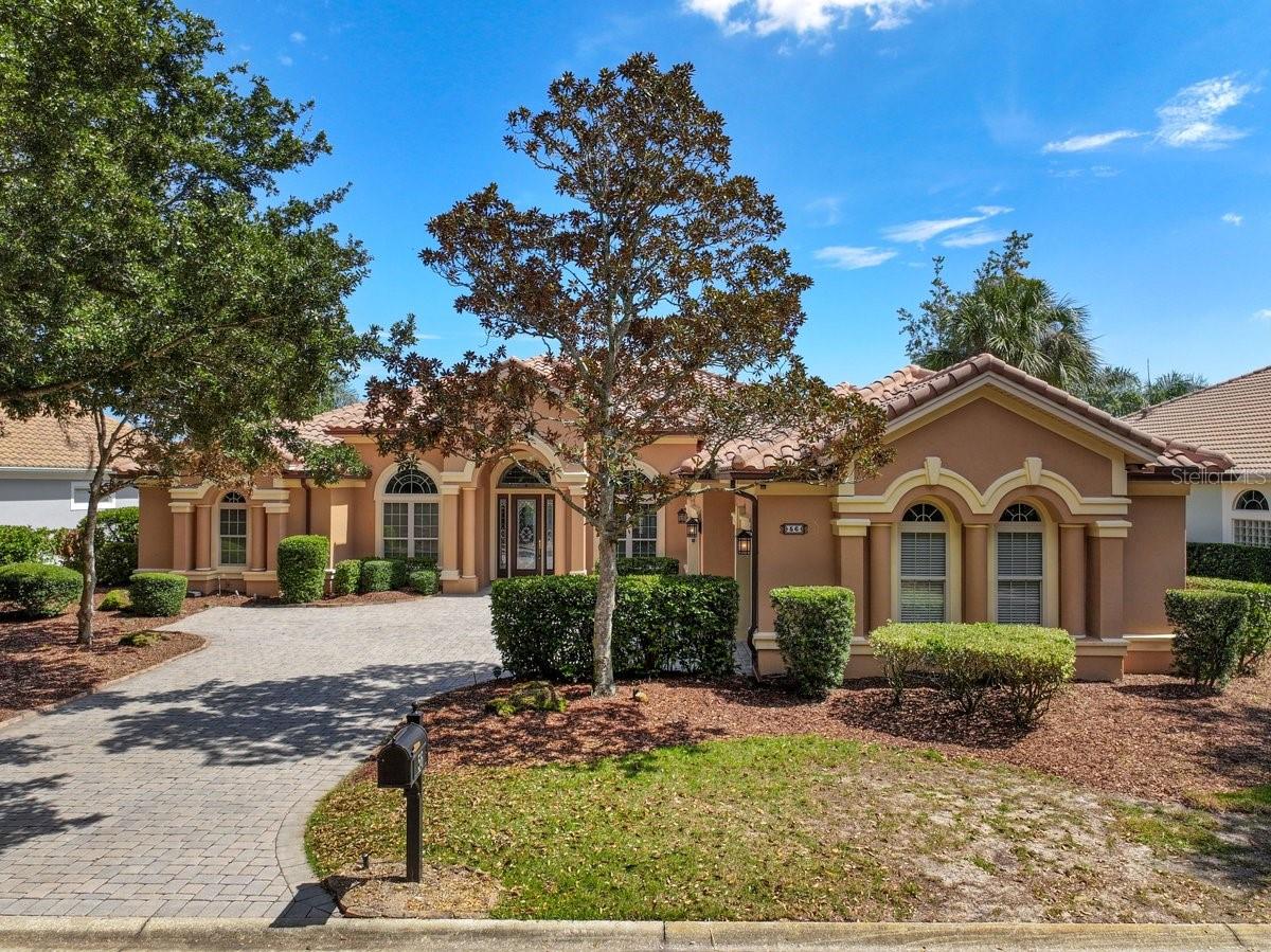 Old-world craftsmanship like this isn't built anymore. In Ocean Hammock, it's waiting for you. This tile-roof Mediterranean sits on a deep lakefront lot shaded by old oaks, with 3 bedrooms and 4 full baths with study, finished in custom cherry millwork, tile and stained glass. A leaded-glass entry with sidelights and an arched transom opens to a foyer set with a mosaic medallion. Marbleized columns frame the formal living and dining rooms, each finished with tray ceilings, lit arched niches and glass display shelving, while sliders open to the lanai.The kitchen is made for serious cooking, with cherry cabinetry, a granite peninsula with a gas cooktop and seating, a second prep island with its own sink, and a carved stone farmhouse sink. A panel-front built-in refrigerator, a wall oven with a warming drawer and an appliance garage complete the space. A separate butler's pantry adds a second sink, a microwave and more storage. The kitchen opens to the family room, where a fireplace is flanked by built-ins beneath an arched clerestory window and a slider looks out over the lake. The study has a coffered ceiling and a full wall of custom cherry cabinetry and shelving.The primary suite pairs a tray ceiling with a sitting area, French doors to the lanai and built-in dressers. Its bath offers a dual granite vanity, a glass-block walk-in shower with body sprays and a bench, and a jetted tub set between columns beneath a stained-glass window.Outdoors, a colonnade of arches runs the length of the covered lanai, which has a bead board ceiling, fans, recessed lighting and a summer kitchen with a sink and cabinetry. Past the arches, a stone-edged [spa/plunge pool] with a rock feature sits under the screen enclosure facing the water. Beyond the cage, the lawn slopes to the lakeshore, with a paver circle and fountain in between. A pool bath opens directly to the lanai. A laundry room with a utility sink and cabinetry, along with a 3-car split garage, rounds out the home.-FULL HOUSE GENERATOR!!!An optional membership to the Hammock Beach Club opens access to the resort and all of its amenities.