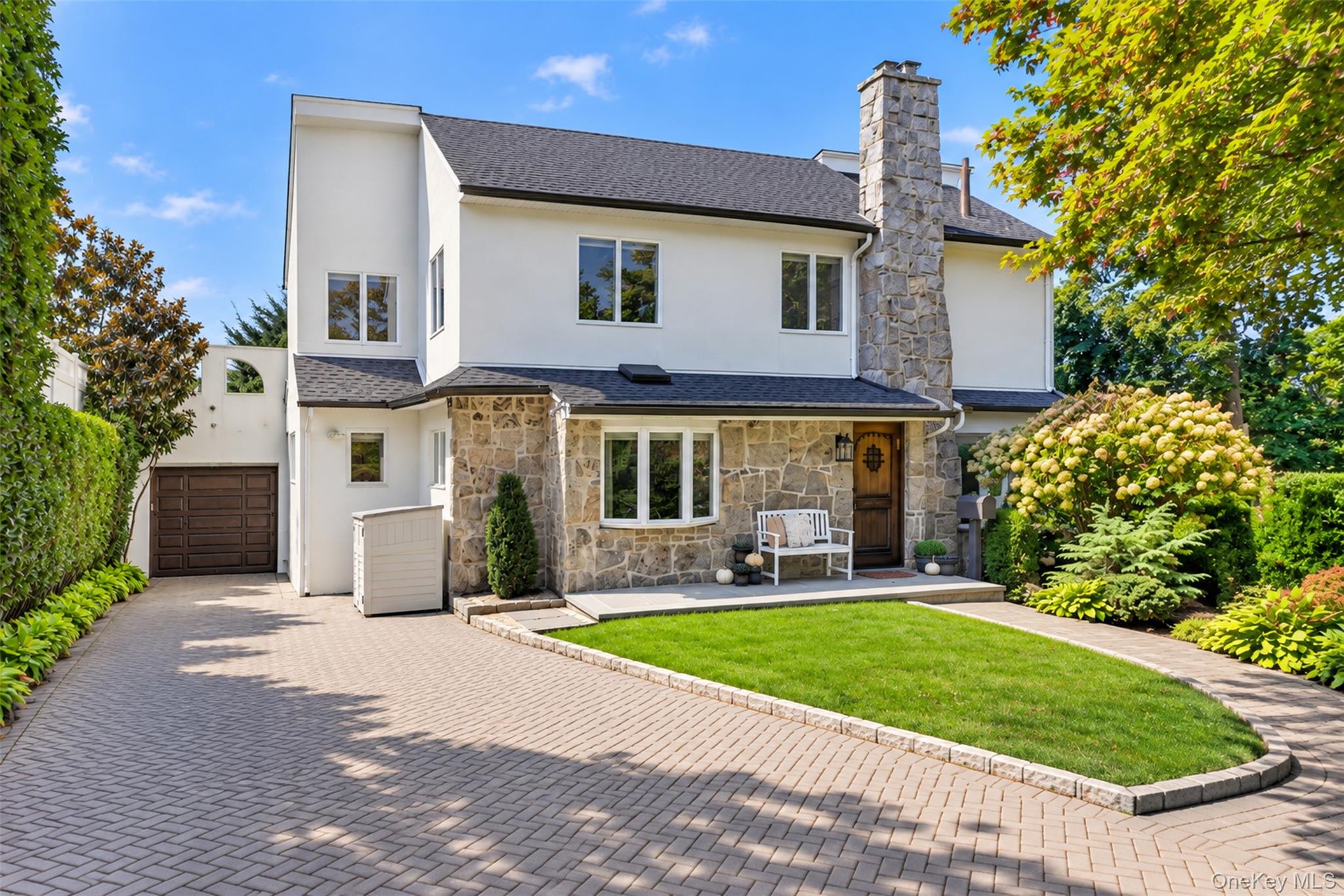 THIS IS A HOME THAT MUST BE EXPERIENCED !! Set on a magnificent 82x100 property, this beautifully appointed Little Neck Hills residence offers something photographs and measurements alone cannot capture. Designed with warmth and texture throughout, the home is expansive where it matters, with virtually every space thoughtfully considered for the way people actually live. The stunning open first floor offers both a generous living room with gas fireplace and a beautiful great room—creating an effortlessly airy everyday living as well as gracious entertaining. At its heart, the spacious custom eat-in kitchen pairs exceptional design with serious functionality, featuring top-of-the-line appliances, abundant cabinetry and storage, and thoughtfully conceived space for cooking, dining and gathering. With 4 bedrooms and 3.5 baths, the home balances shared living with beautifully appointed private spaces. The primary suite is a destination of its own, highlighted by a state-of-the-art bath designed with the comfort, materials and finishes of a private retreat. Throughout, fine craftsmanship and sophisticated details create a quiet sense of quality rather than excess. The exceptionally versatile finished lower level sets itself apart with ceiling heights of approximately 7.5 to 8 feet, creating genuinely livable space with tremendous flexibility for guest accommodations, recreation, a home office, fitness or additional gathering. And then there are the remarkable grounds. Nestled on a quiet, low-traffic cul-de-sac, the exquisite landscaping and hardscaping transform the generous property into a seamless extension of the home, with inviting spaces for dining, entertaining and serenity surrounded by meticulously planned mature plantings and privacy. Extensive improvements throughout reflect thoughtful investment not simply in how a home looks, but in how beautifully and comfortably it lives, a true turn-key retreat. Every space has been considered. Every detail has a reason. This is a home that must be experienced !!