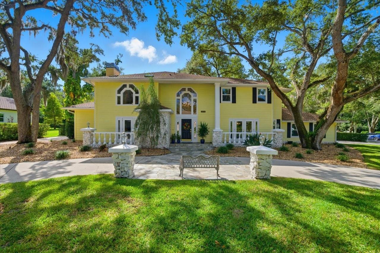 Tucked away in a quiet "hidden" retreat neighborhood, high and dry, non evacuation zone and conveniently central to all of Dunedin's amenities, this elegant Two-Story Estate with Pool and Expansive Grounds is truly special. Welcome to Indian Creek Court. This stately 4-bedroom + den and bonus room, 3.5-bath residence with a 3 car side load garage is perfectly situated on a spacious, beautifully landscaped lot in one of Dunedin’s most desirable neighborhoods. Classic charm meets modern comfort in this impressive two-story home, offering ample room for both relaxing and entertaining.  Inside, you’ll find formal living and dining rooms, ideal for gatherings and special occasions, as well as a warm, wood-paneled office or den—perfect for remote work or a quiet retreat. The kitchen and family areas flow seamlessly to the outdoor living spaces, creating a perfect setting for Florida living at its finest. Upstairs features three additional bedrooms, two baths and a bonus room that can be used for a second family room, media room, gym, or whatever you dream up.
Step outside to your private oasis featuring a sparkling pool, expansive decking, gazebo, and plenty of open yard space for recreation or gardening. The meticulously maintained grounds provide a tranquil backdrop for morning coffee, weekend entertaining, or sunset relaxation.  With its blend of timeless architecture, generous living spaces, and a resort-style backyard, and multiple recent upgrades including impact windows and doors and a whole house generator, this exceptional Dunedin home offers a rare opportunity to enjoy luxury, comfort, and privacy just minutes from the charming and bustling shops, restaurants, and waterfront parks of downtown Dunedin.
