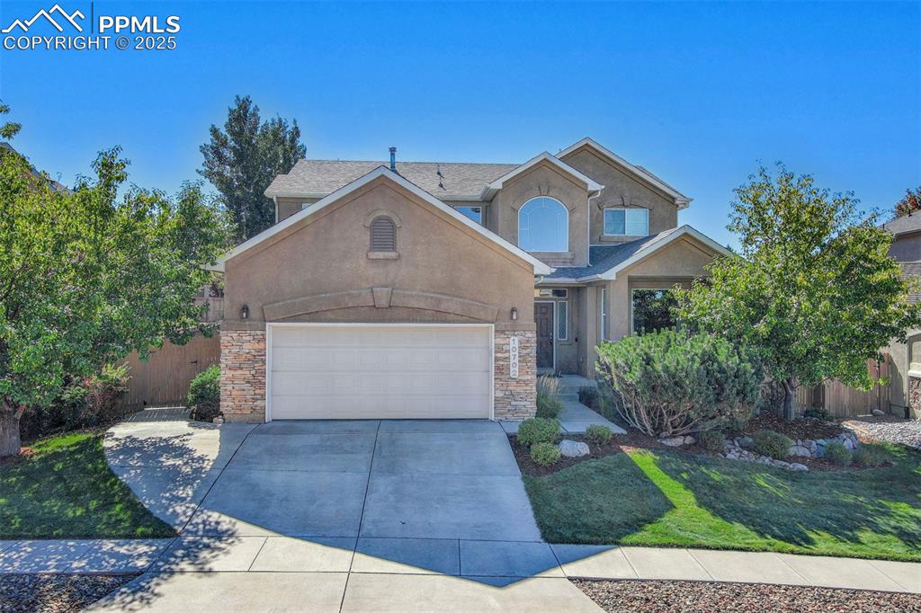 Tucked away on a large private lot in the desirable Bison Ridge at Kettle Creek community, this stunning 2-story stucco home with stone accents offers 5 bedrooms, 4 baths, a dedicated office, a 3-car tandem garage, and 3,951 total square feet of thoughtfully designed living space. You'll immediately notice the formal living or dining space and the gorgeous staircase with soaring ceilings as you enter the home. The main level boasts an open-concept layout with a gas fireplace, expansive windows, 9-foot ceilings, hardwood flooring, and brand-new carpet. The spacious kitchen is equipped with sleek black stainless steel appliances, Corian countertops, a center island, and a versatile corner pantry. A bright dining area flows seamlessly to the extended deck and beautifully landscaped backyard, complete with mature trees for added privacy. A full bath, large mud/laundry room with ample storage, and a main-level office or flex room provide additional convenience and flexibility. Upstairs, you’ll find four bedrooms, including a vaulted primary suite featuring a large picture window with stunning views of Pikes Peak and the Front Range, a large 5-piece ensuite bath, and dual walk-in closets to complete the space. The finished basement is designed for entertaining, featuring a spacious rec area, a full bath, a generous fifth bedroom, and a custom oversized solid red oak wet bar with seating for nine, cork flooring, a mirrored wall with under shelf lighting, wine and beverage cooler included! Additional highlights include central air, two-50 gallon hot water heaters, a whole-home humidifier, two owner entries (one through the spacious mudroom/laundry and one near the front entry), and a peaceful yet connected location just minutes from Interquest Parkway, I-25, and the Powers corridor. What do they say? Location, location, location! Schedule a showing today!
