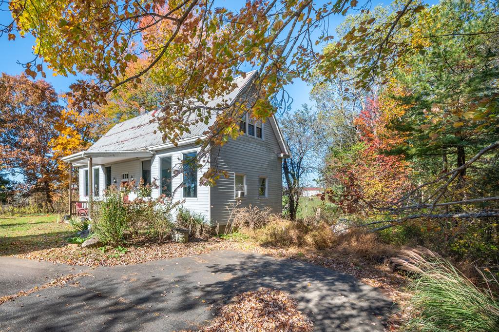 Discover this whimsical and private retreat. This inviting home features an open floor plan with soaring ceilings, a bright living room filled with natural light, and a cozy wood-burning stove that creates a warm, welcoming atmosphere. With 2 bedrooms and 1 full bathroom, the home offers easy, low-maintenance living. Upstairs, a spacious loft runs the full length of the house, ideal for extra sleeping space, a home office, or a game room to enhance rental appeal. The flat front yard is ready for a garden, outdoor entertaining, or guest relaxation space. Full of character, this property is a fantastic option for those seeking a peaceful getaway. The property could also be an income producing short-term rental, or a charming place to call your very own.