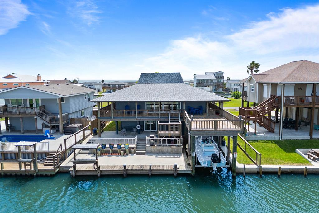 Welcome to waterfront living at its finest. This stunning coastal retreat at 112 Port Royal has been completely remodeled and upgraded from the inside out, leaving nothing untouched. Thoughtfully rebuilt with superior craftsmanship and modern efficiency, this home is ready for its next chapter &mdash; and it's ready to impress from the moment you pull up. Arriving guests will immediately appreciate the expansive front parking area, perfect for holiday weekends and large gatherings. Step inside to discover an open, airy floor plan bathed in natural light with sweeping water views that set the tone for the coastal lifestyle that awaits.The island kitchen is a chef's dream, featuring gorgeous quartz countertops, abundant cabinetry, GE appliances, and a gas stove &mdash; ideal for cooking up fresh catch or entertaining a crowd. The large open living area flows seamlessly to the wraparound deck and an oversized deck built directly over the water, giving you front-row seats to unforgettable sunrises, sunsets, and the peaceful rhythms of coastal life. The home offers three bedrooms, four bathrooms, plus a flex space that comfortably accommodates overflow guests &mdash; making this an exceptional property for family getaways or investment potential. Every inch has been upgraded with quality and longevity in mind, including spray foam insulation for maximum energy efficiency, new plumbing, upgraded electrical, new HardiePlank siding, a tankless water heater and generator. Peace of mind comes standard here with a security system already in place. And for the boating enthusiast, the covered boat slip with a 12,000 lb boat lift and fish cleaning station make this a true angler's paradise. Sold fully furnished in coastal style, this home is truly turnkey &mdash; whether you're making it your primary residence, weekend escape, or vacation rental investment. Properties like this don't come along often. Come see why 112 Port Royal is where great memories are made.
