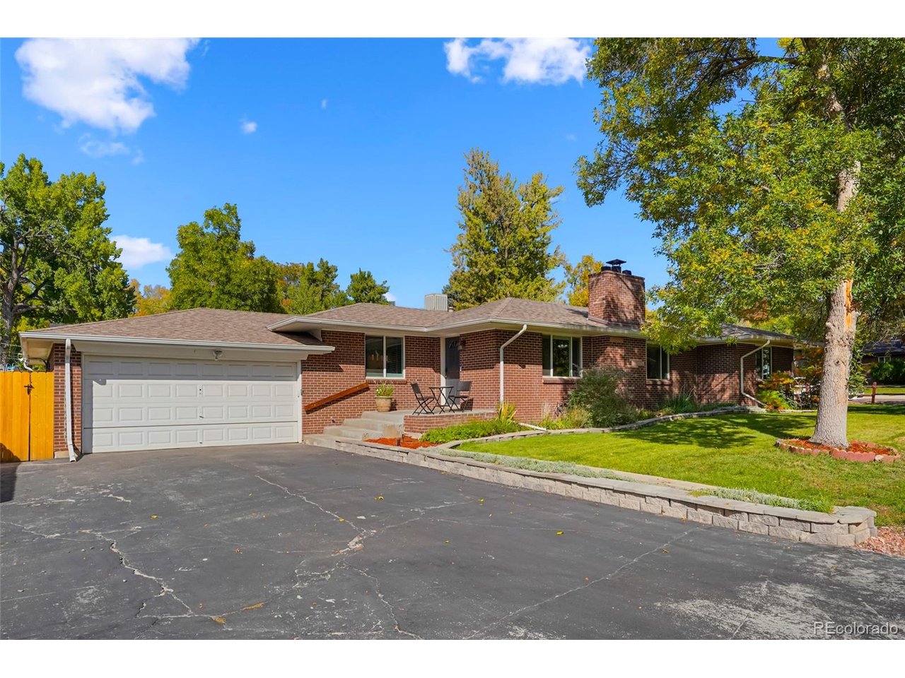 Welcome to this stunning 3-bedroom, 2-bath ranch home set on a large corner lot along a quiet street in Wheat Ridge. This home pairs inviting interiors with generous outdoor space and convenient access to local amenities. As you enter, you're greeted by oak hardwood floors refinished in 2024,and a strong sense of pride of ownership. The kitchen features quartz countertops and a custom backsplash. Additional features include a spacious primary suite, double-pane windows, a newer roof, and ample storage throughout. The updated patio off the well lit kitchen creates a great space for indoor/outdoor living. Outside, you'll find mature trees and a freshly landscaped yard, along with a large fenced grassy area to the west of the home that is perfect for relaxing, playing, or entertaining. A two-car garage provides plenty of room for parking and storage, while the large driveway offers parking for several vehicles or an RV. Enjoy close proximity to Crown Hill Park, Wheat Ridge Recreation Center, Gold's Marketplace, and the restaurants and shops along 38th Avenue and Kipling Boulevard. A great Wheat Ridge location with parks, shopping, dining, and recreation close by.
