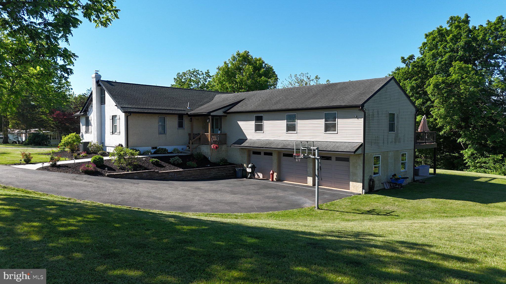**Offer deadline 5PM Saturday** Welcome to 44 Worman Road, a beautifully updated ranch home set on 4.85 private acres in the Daniel Boone School District. Offering more than 2,500 square feet of living space, this unique property seamlessly blends the charm of its original 1930 construction with the comfort and convenience of a thoughtfully designed 2010 addition. The heart of the home is the stunning gourmet kitchen, featuring custom cabinetry, a massive center island, pantry, wine cooler, and abundant workspace for cooking and entertaining. The kitchen flows effortlessly into the spacious dining area and family room, where vaulted ceilings, an electric fireplace, and luxury vinyl plank flooring create a warm and inviting atmosphere. The private primary suite, located within the addition behind a 6-inch wall with added insulation for enhanced sound reduction, serves as a true retreat with a spa-inspired en suite bathroom complete with heated floors, double vanity, and stall shower. Three additional bedrooms are situated in the original portion of the home and share a beautifully renovated full bathroom. A formal living room and dedicated laundry room provide additional functionality and living space. Throughout the home, you'll find luxury vinyl plank flooring, craftsman-style molding, and updated light fixtures that add a cohesive and modern touch. Step outside to the large rear deck overlooking the expansive backyard and wooded backdrop, offering exceptional privacy and a peaceful setting for outdoor enjoyment. Additional features include an electric dog fence and an oversized three-car garage on the lower level. For added peace of mind, a brand-new septic system has already completed the design phase and will be installed prior to closing. If you've been searching for a property that combines acreage, privacy, modern updates, and timeless character, 44 Worman Road is a rare opportunity you won't want to miss.