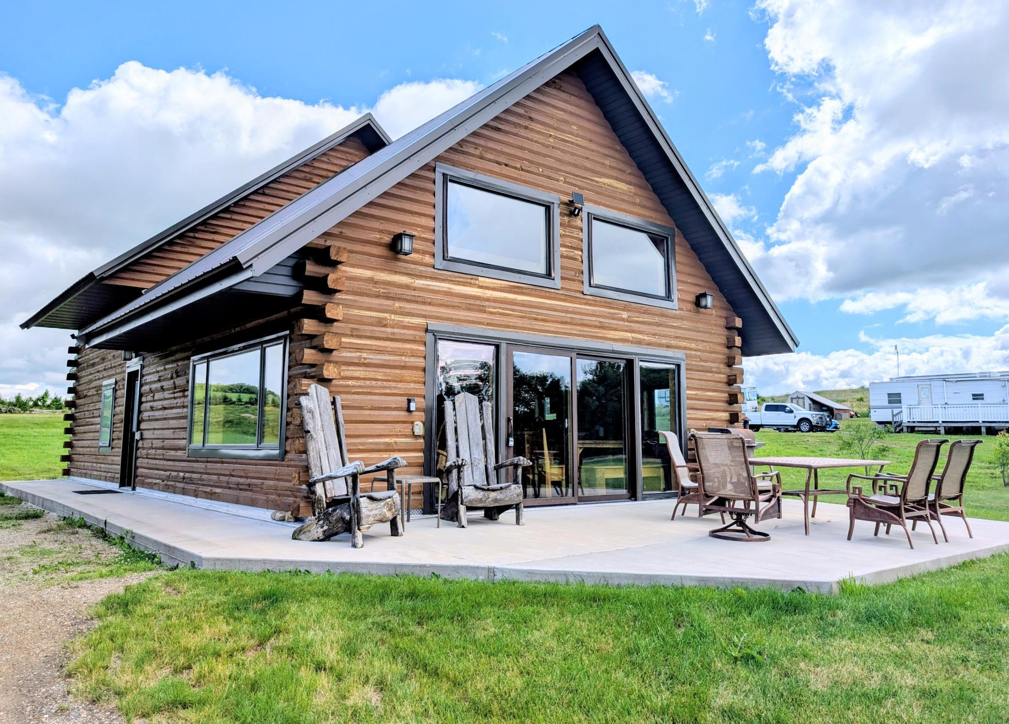 This beautiful log home sits on a 1.5 acre lot with 150 feet of lakeshore with 3 bedrooms, 3 bathrooms selling fully furnished with gorgeous quality furniture. The main level has breathtaking beamed vaulted ceiling, open concept and large windows facing the lake. Sliding doors lead out to the patio for grilling or just enjoying the view of the lake and sunset.  Closer to the lake there is a stamped concrete patio with firepit in the middle. Built in 2020 and has only been used as a VRBO. The home still looks and feels brand new inside.  All cabinetry is knotty hickory.  The kitchen has black stainless steel appliances and a center island.  The main level has vinyl plank flooring. There is a 1/2 bath with a pretty onyx counter top and a private full bathroom in the main level primary bedroom.   There is also a large walk in closet with washer and dryer. Upstairs you can take in the beautiful lake view from the loft area to be used however you need.  There are 2 bedrooms with double bunk beds in each room and another full bathroom. The Dock will stay.  The lot has plenty of room to build a garage/shed.  Available for quick closing to enjoy the Fall lake time!
