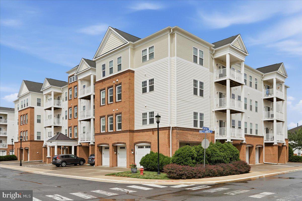 **Enjoy the ease of one-level living in the highly sought-after Stone Ridge community!** This beautifully maintained luxury elevator condo offers the perfect combination of comfort, convenience, and low-maintenance living, all within a master-planned community ideally located along Route 50 with easy access to Washington Dulles International Airport.Featuring 3 bedrooms, 2 bathrooms, and over 1,500 square feet of thoughtfully designed living space, this move-in-ready end-unit boasts an open floor plan, 9-foot ceilings, and abundant natural light. Recent updates include wide-plank luxury vinyl flooring, new carpet, and fresh paint throughout, creating a modern and welcoming atmosphere.The spacious kitchen is designed for both everyday living and entertaining, offering a breakfast bar, stainless steel appliances, and seamless flow into the main living areas. Relax by the cozy fireplace or step outside to enjoy your private balcony.The generous primary suite serves as a peaceful retreat with a large walk-in closet and private ensuite bath. Additional features include professionally installed ceiling fans and window blinds throughout, a one-car garage, extra parking, and a rare climate-controlled storage room conveniently located on the first floor near the garage.Residents of Stone Ridge enjoy an exceptional lifestyle with access to community pools, tennis courts, walking and biking trails, a clubhouse, library, shopping, medical facilities, and public transportation options nearby.**Offering comfort, convenience, and outstanding community amenities, this home is ready for its next owner. Schedule your private tour today!**