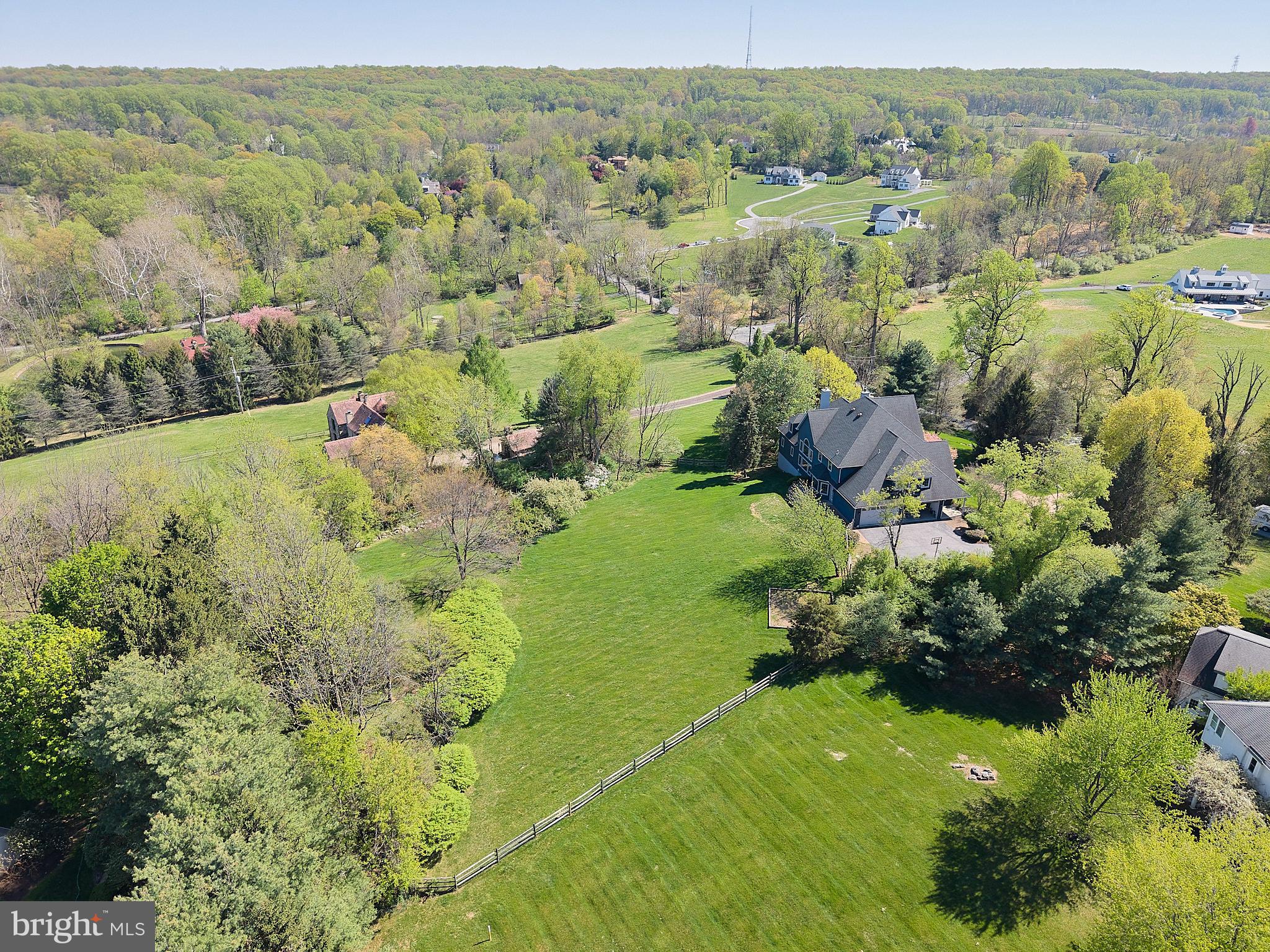 A rare offering in the heart of Chester Springs- just minutes from major roads and highways- this exceptional estate home blends privacy, elegance, and everyday flexibility. Set behind a gated driveway, the approach alone sets the tone for something truly special.  Perfectly positioned on a beautiful two acre homesite, the backyard offers and ideal setting for recreation, entertaining, or simple enjoying the peaceful surroundings and captivating views .  This impressive 6 bedroom home offers a thoughtful blend of timeless design, generous living spaces, and refined finishes throughout. Set on a picturesque lot , the property provides both privacy and convenience.  Hardwood floors extend through much of the home, complemented by detailed millwork and well-designed living spaces. The expansive kitchen features stainless steel appliances, wine refrigeration, solid wood cabinetry, quartzite countertops and a large walk-in pantry. Ample space and casual dining areas make the kitchen both functional and inviting. The main-level primary suite offers a private retreat with two walk in closets and a spacious ensuite bath.  An adjoining office with custom built ins and a gas fireplace provides flexible space for work and relaxation. Upstairs, five bedrooms offer flexible living arrangements, including a private guest or au pair suite, two bedrooms with ensuite baths and a Jack and Jill bath connecting the additional two rooms.  The exterior features usable grounds with open views, offering space for outdoor living and recreation. the 4-car garage provides parking and storage. This extraordinary property located in the Downingtown East School District with easy access to Routes 401 and 202, this home offers a combination of space, setting, and accessibility. Elegant, expansive, and ideally located- this is a home where luxury meets lifestyle in one of Chester Springs most desirable settings.