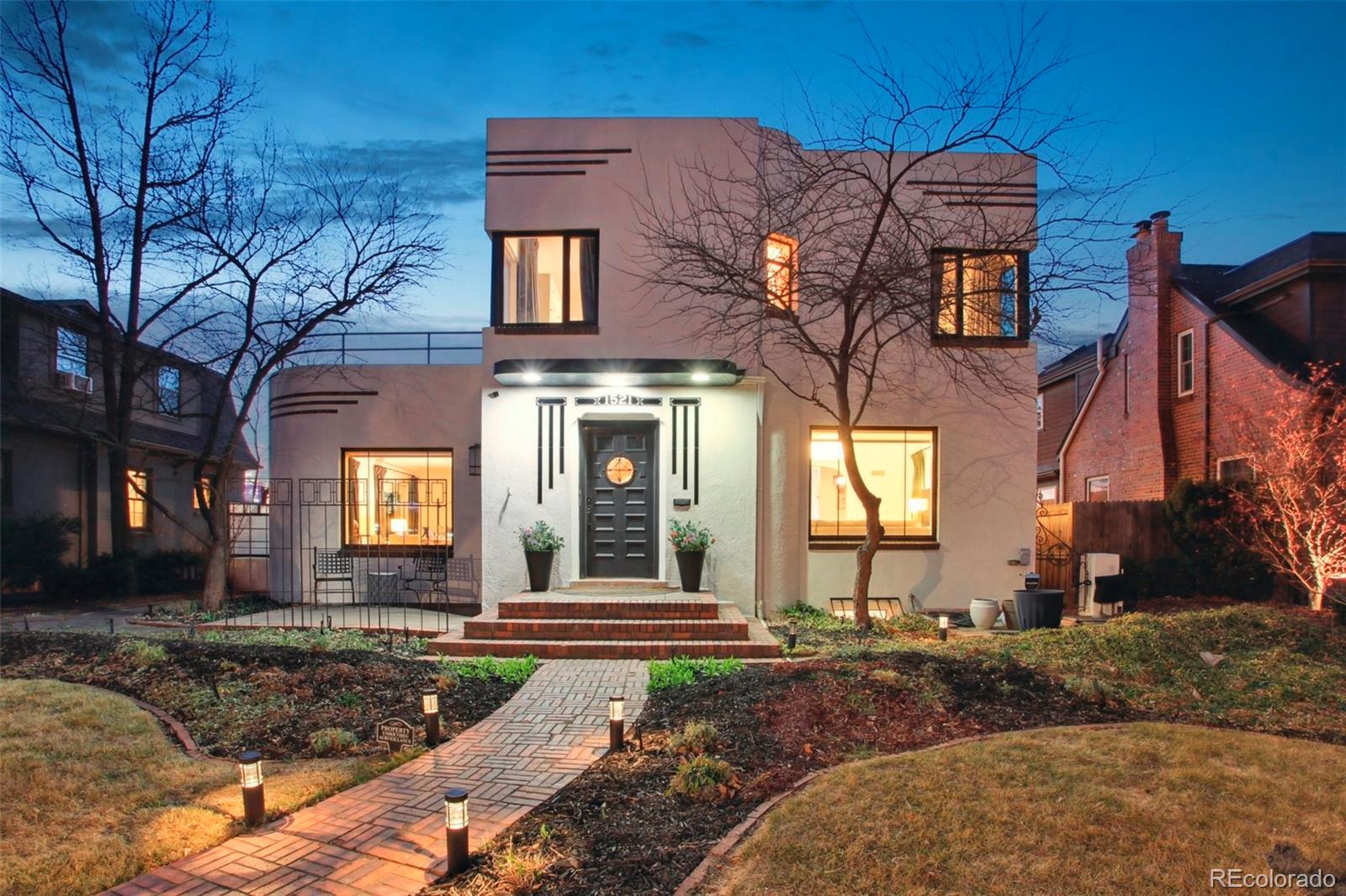 OPEN HOUSE SAT 3/7 from 11-2pm!You don’t want to miss this luxurious Art Moderne architectural beauty in coveted South Park Hill! This exceptional 4-bedroom/3.5-bath home offers more than 3,600 sqft of refined living space and underwent a $500,000+ renovation in 2022–2023 by Chris George Interiors, blending preserved original details w/elevated modern finishes. On the main floor, you’re welcomed by an elegant foyer w/its original staircase + custom terra cotta tile, complemented by original quarter-sawn oak floors throughout. The front living room flows into a breakfast nook and stunning chef’s kitchen featuring a custom white oak display cabinet, granite counters, custom backsplash, handmade tile floors, luxury Big Chill/Bluestar appliances, and two pantries. The south side offers a spacious great room for entertaining, plus a 1/2 bath w/adjoining office or optional 5th bedroom. The expansive primary suite includes California Closets + a spa-like bath wrapped in Carrara marble and handmade Zellige tile, complete with a steam tub/shower for two. Mountain views await from the rooftop deck! Two additional bedrooms compliment the upper level along with a secondary bathroom that includes similar quality finishes as the primary. The lower level offers flexibility with a large family room, 4th bedroom w/en-suite bath, wall heaters to keep the space cozy, and a spacious laundry room w/the original walk-in vault. The private backyard boasts a water feature, dining area, multiple seating spaces, garden sink, and access to the 2-car detached garage. Major upgrades completed during the renovation include all-new windows, roof, and HVAC system, as well as updated plumbing, main waterline, PVC sewer line, electrical, and radon abatement system. Easy access to Park Hill amenities, just 2 miles from City Park, the Denver Zoo, and the Museum of Nature & Science, plus a short drive to Downtown Denver. This is a rare opportunity to own a truly distinctive South Park Hill showpiece!