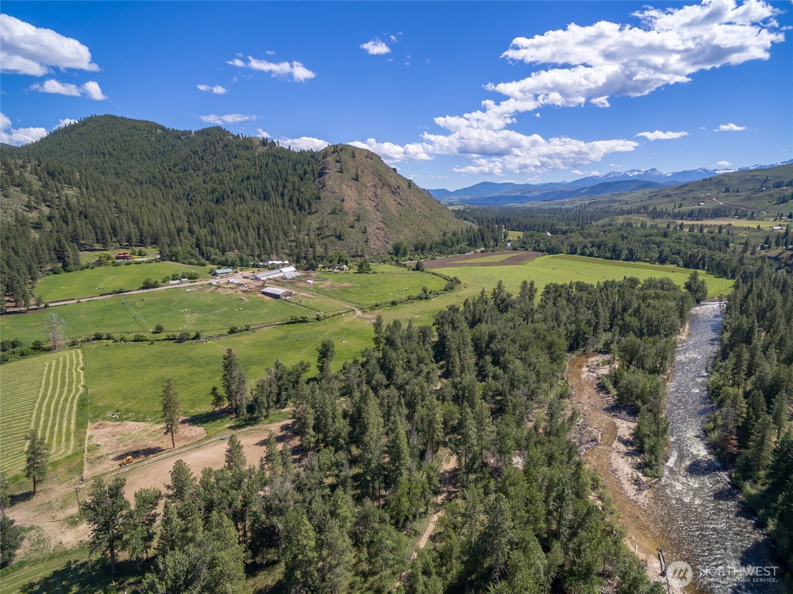 A few miles north of the small western town of Winthrop, WA, the Chewack River Ranch offers the opportunities to run  your own cattle ranch, farm your own acreage, and produce income off the many amenities this ranch has to offer. Including  30,450+/- acres of leased ground and 513+/- deeded acres that includes frontage along the Chewuch River, a valley of irrigated  farmland and the west facing slope. 5 rental cabins allow for increased income potential. Outdoor arena, round pens, and  pastures.  From the River to the ranch house, and the cabins to the barn, there is so much beauty wrapped in to one property that you  won’t want to miss out on this ranch. Enjoy all 4 seasons and the beauty that comes with them at the Chewack River  Ranch.