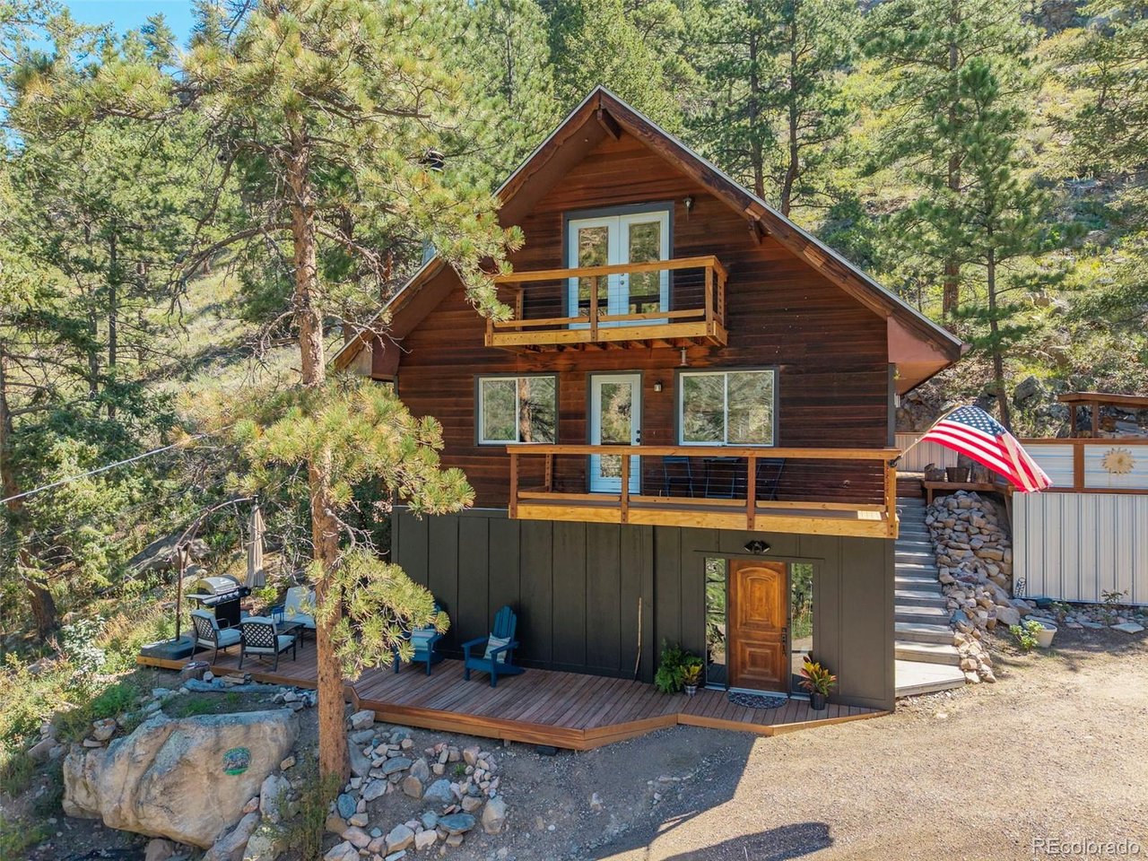 Beautifully transformed with extensive recent updates, this Big Thompson Canyon home combines thoughtful craftsmanship, modern functionality in an exceptional natural setting. The fully remodeled kitchen is a standout, featuring leathered granite countertops, solid maple cabinetry, stainless steel appliances, double wall ovens, a ducted hood, porcelain tile backsplash, updated lighting and wide-plank 3/4-inch solid maple flooring. The inviting living room retains its mountain character with a wood-burning fireplace surrounded by natural moss rock, while the former attached garage has been thoughtfully reimagined as a spacious entry mudroom and separate laundry room. Multiple levels and outdoor living spaces-including covered balconies, an uncovered porch and a wood deck-provide numerous places to enjoy the forested canyon surroundings and views toward the Big Thompson River below. The property backs directly to Roosevelt National Forest, providing immediate access to thousands of acres of public land, while high-speed Pulse internet adds an important modern convenience. Conveniently located near the junction of Highway 34 and County Road 43, the property sits approximately halfway between Loveland and Estes Park-just 13 miles from Estes Park and 16 miles from Loveland, with the entrance to Rocky Mountain National Park approximately 16 miles away. This beautifully updated home offers an uncommon combination of craftsmanship, recreation, accessibility and connection to the natural surroundings of the Big Thompson Canyon.