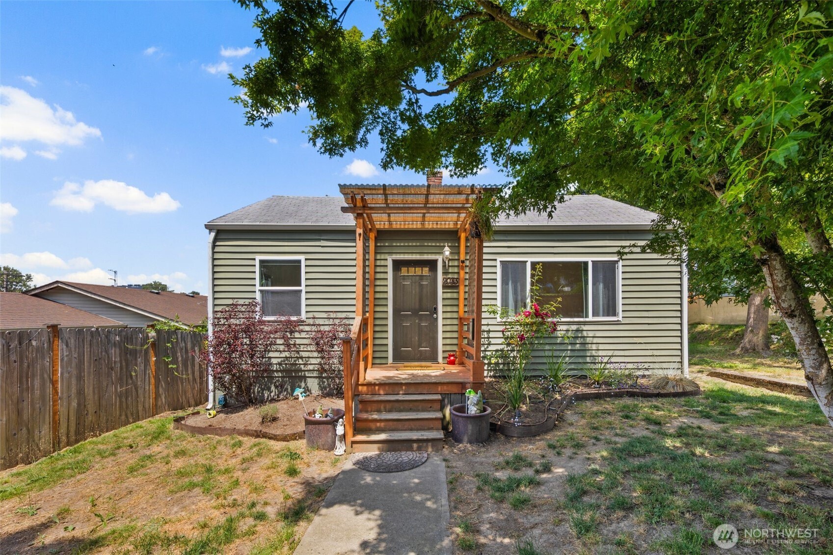 Single-story rambler home on a large fenced lot in Tacoma’s Eastside. Detached two-car garage/shop with alley access. RV parking through the gate with hot and cold water hookups. Inside offers hardwood floors, newer carpet, fresh paint, and updated lighting. Kitchen includes cosmetically upgraded counters, modern cabinets, and stainless appliances. Gas stove! Remodeled bathroom and updated fixtures. Major system upgrades include plumbing, sewer line, tankless water heater, and furnace. Convenient location near parks, schools, and freeway access. Move-in ready with room to expand or add an ADU.