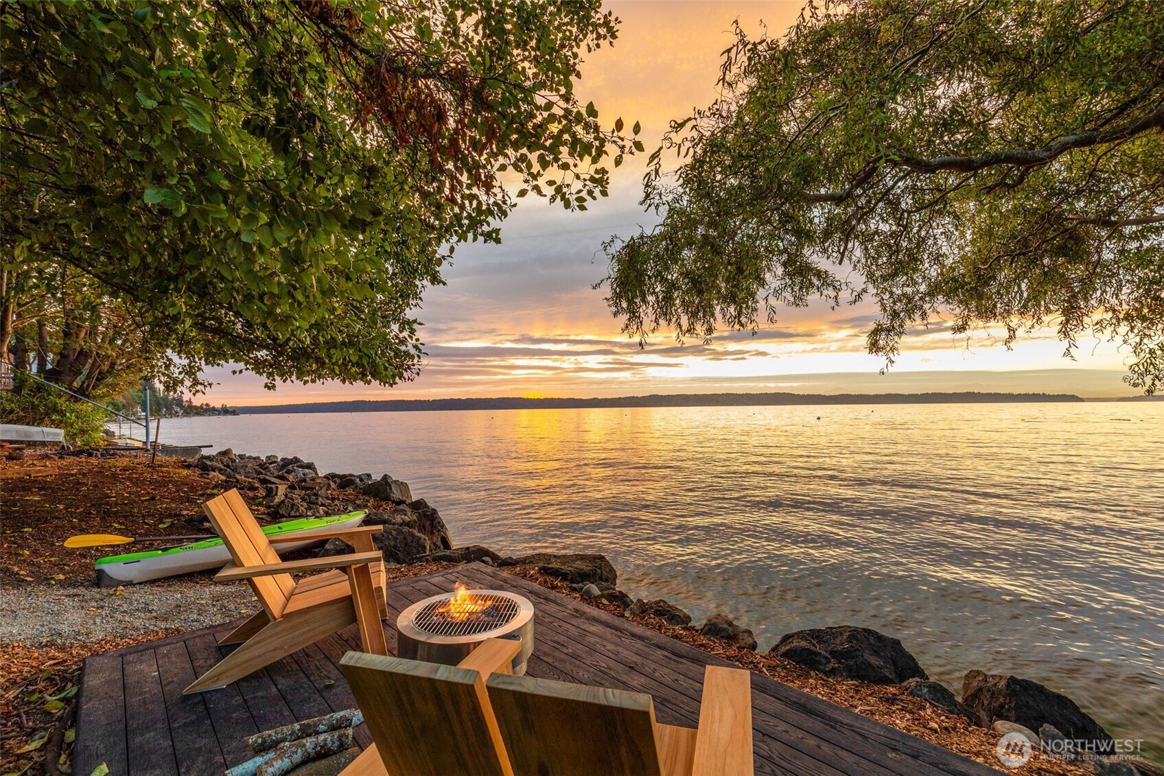 Rare offering in sought-after Three Tree Point. Terrain Signature Properties unveils a fully reimagined Craftsman perched above Puget Sound, where timeless charm meets modern refinement. This 4BD/2.5BA coastal home offers all the charm with none of the maintenance, capturing sweeping water and mountain vistas from nearly every room. Designed for effortless Northwest living, it features open indoor-outdoor spaces and a spa-inspired primary suite that defines relaxation. A private wooded trail leads to your own sandy beach and sunset-viewing deck. With heritage fruit trees, a street-level three-car garage, and a second waterfront parcel, this extraordinary property offers both serenity and investment potential—just 20 minutes from Seattle.