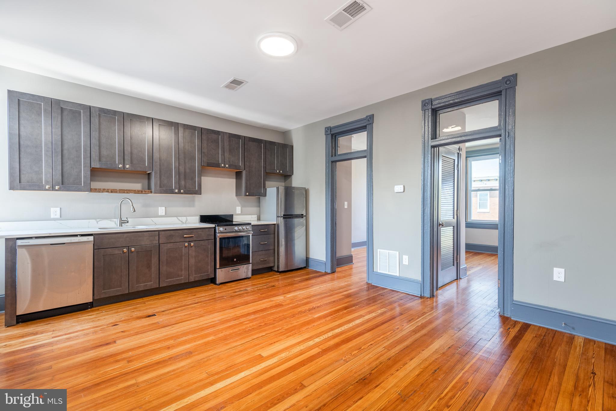 SPACIOUS RENOVATED PENTHOUSE LEVEL APARTMENT IN THE HEART OF FELLS POINT WITH SHARED ROOFTOP DECK AND REAR PATIO! Refinished hardwood floors, updated kitchen w/ granite counters and ss appliances, spacious living area, and 2 bedrooms and 1 full bath. Designated stackable washer and dryer in basement of the building.  Building consists of 4 apartments and main level commercial space. Tenants share access to rooftop deck and rear garden patio w/ built-in seating. Located in the heart of Fells Point and walking distance to the waterfront, restaurants, and shopping!