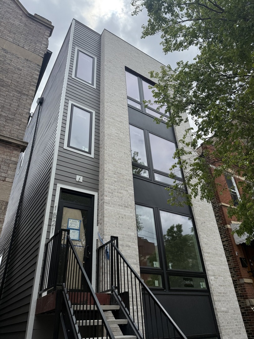 Stunning and luxurious NEW CONSTRUCTION DUPLEX DOWN by a well-known builder, located in a boutique three-unit condo building nestled within a coveted enclave of Pilsen that seamlessly blends urban convenience with tranquil residential living. Spanning approximately 2,200 square feet, this expansive residence is set in one of the neighborhood's most desirable locations-just steps from the vibrant 18th Street corridor and offering exceptional access to the Pink Line (0.3 miles), Halsted Metra (1 mile), Expressways (1 mile), UIC (1 mile), and Harrison Park (0.4 miles), while being surrounded by award-winning restaurants, cultural landmarks, art galleries, and dynamic nightlife. Set within a striking masonry and Hardie exterior, this home lives like a single-family residence and features a generous open-concept living space with soaring 9-foot ceilings and oversized windows that bathe the interior in natural light. The main level showcases a chef's kitchen equipped with custom cabinetry, high-end quartz countertops, a 10-foot waterfall island, premium KitchenAid stainless steel appliances, a full-size pantry, and a breakfast nook-all anchored by custom millwork that flows into the spacious living and dining areas, making it perfect for entertaining. Solid white oak flooring runs throughout, enhancing the clean, modern aesthetic. The serene primary suite features a spa-quality bath with an oversized walk-in shower, a 9-foot double vanity with white oak cabinetry, a walk-in closet, and access to a private front patio. Three additional bedrooms provide versatile options for family, guests, or a home office, while a tiled mudroom, in-unit laundry, and private rear trex deck add convenience to everyday living. Smart thermostat, keyless entry, and one dedicated parking space included. With exceptional scale, refined finishes, and a prime location near transit and culture, this one-of-a-kind home presents a rare opportunity in one of Chicago's most vibrant neighborhoods.