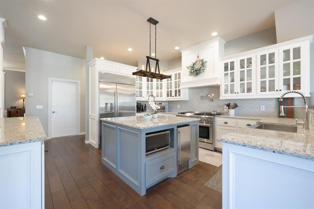 As you walk into this home the sightlines are unbelievable. This upscale home on half an acre with a 3 car garage, offers a commercial grade kitchen- with a new double door GE fridge, prep sink on a large island, built in ice maker, wine fridge, and a Thor stove & double oven, second peninsula with lower level pantry space & pull out shelving, two living spaces, fireplace, two dining spaces, 3 secondary large bedrooms with large /walk-in closets, one Jack and Jill bath, one full bathroom, a half bathroom, a Main Bedroom with a newly renovated Main Bathroom, and a walk-in safe room/laundry all on the lower level. Upstairs offers a large bonus room, a 5th bedroom, and a full bathroom. The extra features are a concrete saltwater pool, pergola, covered back patio, smart sprinkler system, smart garage doors, new fence on E side side of home with an extra concrete pad, large all brick storage shed, full gutters, neighborhood walking trails with fishing ponds. There is a list of updates that is available for review.. Please ask your realtor to print off with disclosures.