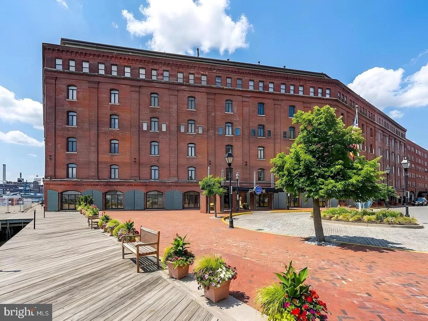Fantastic loft style condo in beautiful Henderson's Wharf!  This 1-bedroom/1-bath condo overlooks the peaceful landscaped courtyard.  The 2-level floorplan provides a quiet lower-level bedroom and bathroom with updated cabinetry in the bathroom.  The main level provides an open layout with a breakfast bar for comfortable dining, updated kitchen with newer cabinetry, granite countertops & appliances.  Both levels are drenched in natural light from large windows overlooking the courtyard.  The deeded parking spot in the secured garage provides convenience and safety.  Henderson's Wharf amenities include a beautifully remodeled lobby with stylish furnishings and coffee station, front desk, courtyard and nicely appointed hallways.  Enjoy the charm of the cobblestone streets and be within walking distance of the waterfront promenade, shops, dining options, yoga, Hopkins, Harbor Point & Harbor East, Downtown and Canton.  Henderson's Wharf is steps away from all of these conveniences but is tucked away in a quiet corner of the neighborhood!  New carpet to be installed prior to settlement.