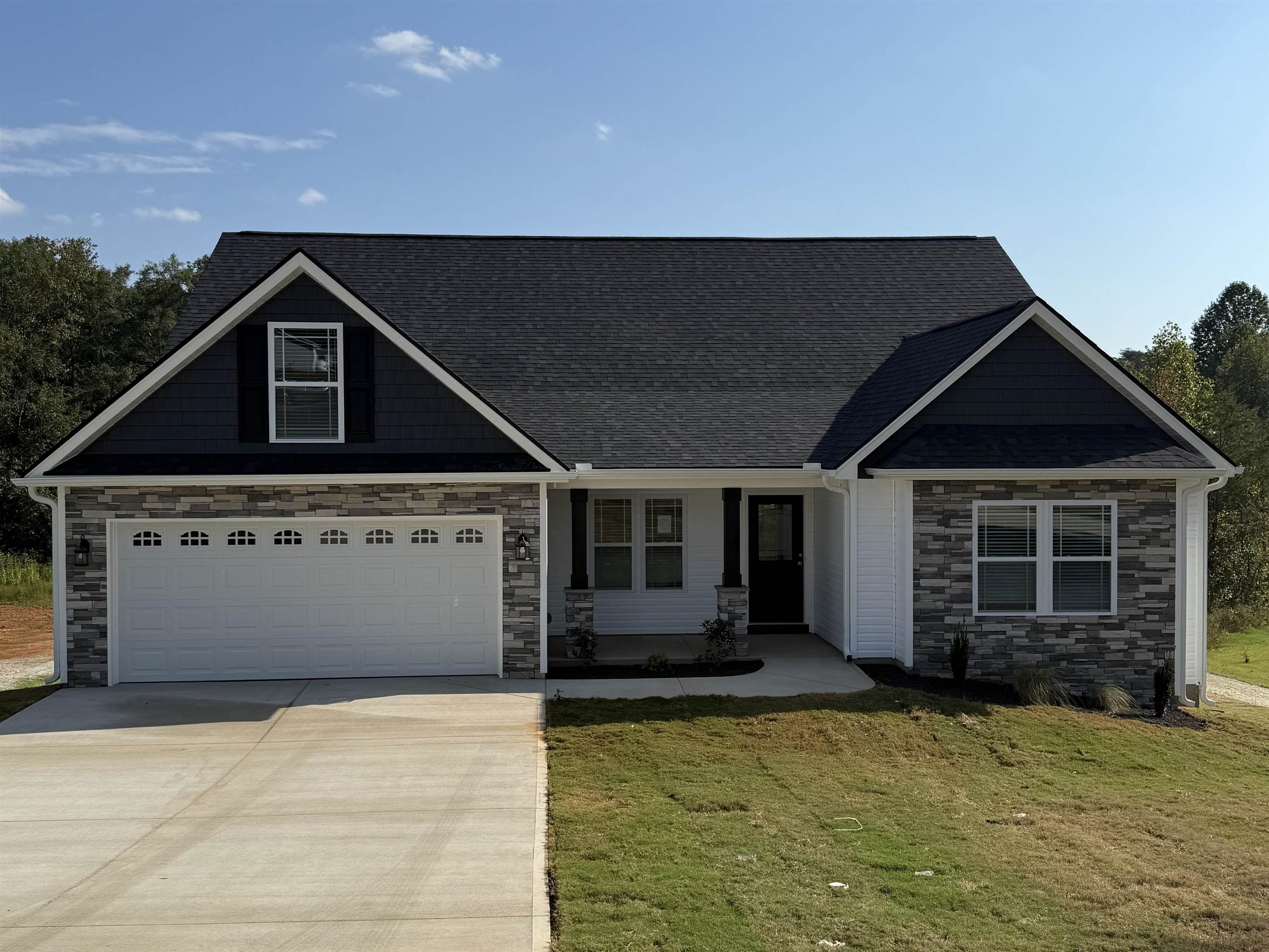 Builder Incentive of $7,500 available! Fridge and Blinds Included!  Welcome to the Beaumont floor plan. This spacious 3 bedroom, 2 1/2 bathroom home sports several upgrades including an extended patio, half stone fireplace, luxury vinyl plank flooring, and more! Situated on over half an acre lot in the new Fall Creek community in Inman. Call today for more info!