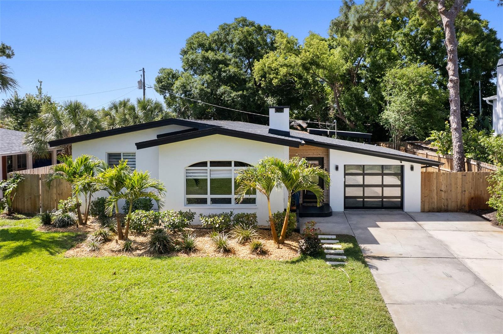 PRICE REDUCED - MOTIVATED SELLER! Don't miss the opportunity to own this unique and stunning home in a highly desirable neighborhood where homes are rarely available. This beautifully landscaped, open concept home features 4 bedrooms and 3 baths, with a modern interior filled with natural light throughout. Situated on an oversized lot with a fenced yard and no HOA, and just minutes from everything St. Petersburg has to offer, the home includes roof (2022), A/C Unit (2023), Windows (2023), a full view garage door with metallic epoxy flooring, Fireplace, LVP Flooring, a Large shower in master bedroom with custom closet, and a spacious driveway. Eagle Crest is centrally located within minutes of shopping, the beautiful gulf beaches and both the Tampa and St. Petersburg Airport.