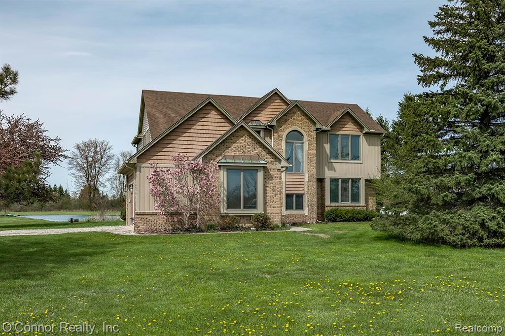 Here’s the place you’ve been waiting for! This well-proportioned 2,700 sq ft colonial sits on 5 beautiful acres, complete with a pond and a 24' x 48' outbuilding—perfect for storing all your toys. The main floor features a spacious living room with a fireplace and soaring ceilings, along with convenient first-floor laundry. You’ll also find a private family room and a large den showcasing custom woodwork. The kitchen and dining area offer plenty of space for gatherings, with a sliding door leading to a deck overlooking the backyard—ideal for watching the kids play, enjoying the pool, and taking in the surrounding wildlife. Upstairs, the large primary suite includes a walk-in closet and full bath. Across the catwalk are two additional generously sized bedrooms and another full bathroom. The full basement provides even more living space with a huge family room, rec area, bar, workout space, and multiple storage rooms. Outside, enjoy new siding, ample parking, and room to roam. Located in the Marysville School District and just a couple miles from I-94, this quality-built home offers the perfect blend of space, privacy, and convenience. A great opportunity for a family looking for acreage, a spacious home, and a versatile outbuilding !