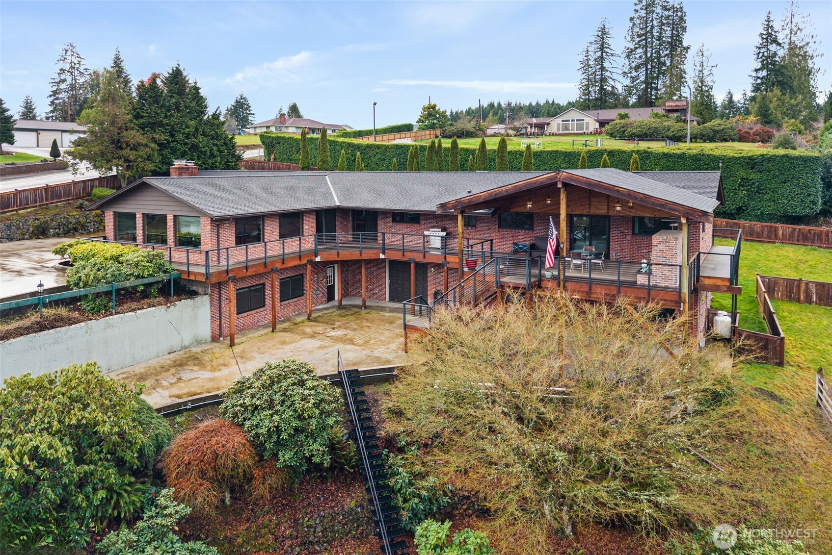 Don't miss this Beautiful Brick Home with sweeping Mtn Views. Home offers outdoor covered walkways, a custom deck with brick fireplace—perfect for BBQs and year-round entertaining. Inside, enjoy high-end finishes and panoramic views from the main floor overlooking Mt. Rainier, & Mt. Adams. Home features lots of storage, 2 bedrooms plus a spacious primary suite. Lower-level rec room and office—ideal for work, hobbies, or guests, a large 3-car garage plus a 1,200 sq. ft. finished shop complete with a ¾ bath, ductless heat pump, and its own electrical panels. With concrete driveways and ample parking, this property is well-suited for multigenerational living, or a home-based business. An extra building lot provides even more potential.