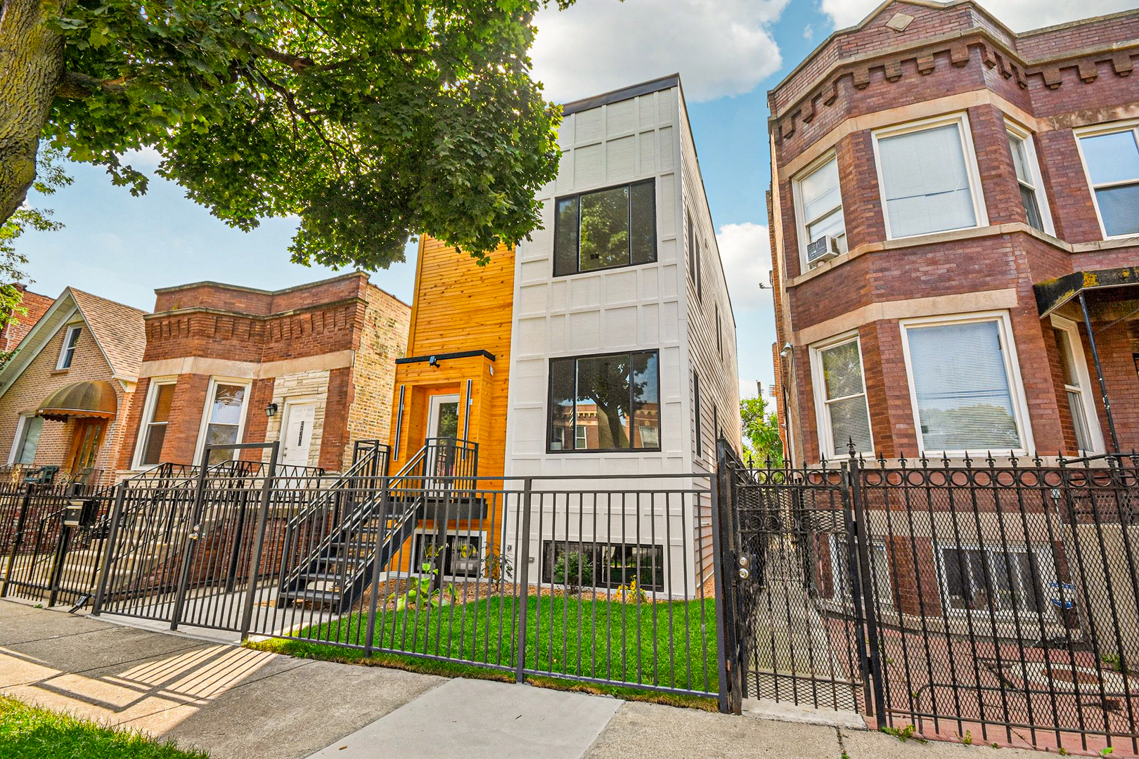 Luxury Meets Modern Living in West Humboldt Park: Welcome to this stunning new construction single-family home, perfectly situated in the rapidly growing West Humboldt Park neighborhood. Thoughtfully designed for both comfort and sophistication, this multi-level residence offers 5- spacious bedrooms, 3.5 luxurious bathrooms, a cozy family room, a flex-room/ space, and multiple outdoor living areas, including an expansive rooftop deck. With a 2-car garage and elegant design elements throughout, this home truly has it all.  Exceptional Interior Design & Thoughtful Layout: Step inside through the inviting front entrance and be greeted by an open-concept floor plan bathed in natural light. The living room, dining area, and chef's kitchen flow seamlessly together, creating a perfect setting for everyday living and entertaining. Large, energy-efficient windows highlight the beauty of the light wood floors that run throughout the home.   The chef's kitchen is a true showstopper, featuring sleek black shaker cabinetry, quartz countertops, a full-height backsplash, and a large island with breakfast bar seating-ideal for casual dining or hosting guests. High-end stainless steel appliances, including a French door refrigerator and an externally vented range hood, add both style and functionality. A walk-in pantry ensures plenty of storage space for all your culinary needs.   Expansive Living Spaces: The lower level boasts impressive 9-foot ceilings, offering a spacious family room, an additional guest bedroom, and a full bath. A versatile oversized room provides the perfect space for a home gym, playroom, or media room, with seamless access to the backyard.    Upstairs, the primary suite is a private retreat, complete with a spacious walk-in closet and a luxurious en-suite bathroom featuring dual showerheads and designer finishes. This level also includes two additional bedrooms and a full bathroom, with one bedroom ideal for a sun-filled home office.    Unparalleled Outdoor Living: A striking staircase leads to the private rooftop deck, offering a serene escape with breathtaking views-perfect for entertaining, relaxing, or enjoying warm summer nights. Additional outdoor spaces include a gracious front porch, a backyard, and a garage rooftop deck, providing multiple options for entertaining and outdoor enjoyment.    Prime Location & Unbeatable Convenience: Enjoy the best of West Humboldt Park with easy access to:   Humboldt Park Boathouse, Beach, Tennis Courts, & Cultural Center   The 606 Trail   Public Transportation   Restaurants, Cafes, & Shopping in Nearby Business Districts    Premium Features & Upgrades:    Hardwood flooring throughout   Dual-zoned heating & cooling   Lower-level entertainment space with beverage refrigerator & additional storage   Spacious laundry room    This exceptional new construction home checks all the boxes-high room count, stunning design, incredible outdoor space, and garage parking. With the neighborhood's continued growth and revitalization, this is not only a dream home but also a smart investment opportunity.  Don't miss out-schedule your showing today and secure your place in one of Chicago's most exciting neighborhoods!