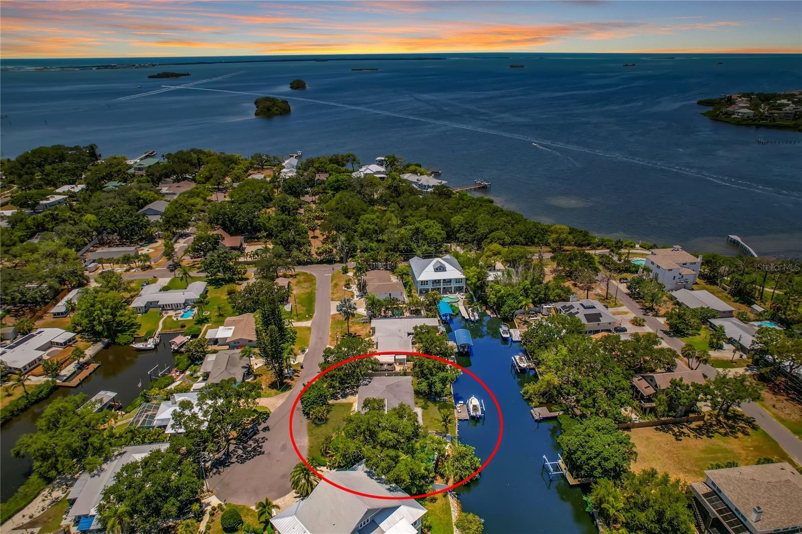 Virtually Staged. Welcome to your own slice of paradise in the charming coastal town of Ozona, Florida! This beautifully updated ranch style waterfront home offers the Florida lifestyle you've been dreaming of, complete with stunning water views, a private, composite boat dock with a 9,000 lb. boat lift and just one turn to the open Gulf! Whether you're heading out for a day on the water or relaxing by your private pool, this home is designed to make every day feel like a vacation. Inside, you'll love the light and bright open floor plan where the beautifully appointed kitchen features granite countertops, a matching backsplash, stainless steel appliances and overlooks the spacious dining and family room. A wall of windows line the back of the home filling the living space with natural light while showcasing the peaceful waterfront views. The thoughtfully designed triple split bedroom floor plan offers privacy for everyone, including a spacious primary suite tucked away from the guest bedrooms. Step outside to the screened lanai where your sparkling pool and outdoor patio create the perfect place to unwind or entertain. The fully fenced side yard offers plenty of room for outdoor games, gardening and your kiddos & pets to run and play. Additional features include hurricane impact windows, sliders and front door, a HUGE walk-in pantry/storage room off the garage, a new pool pump, fresh interior & exterior paint (2026), water heater (2025), A/C (2024), new electrical panel (2022), and the roof replaced in 2017. Beyond the home, you'll fall in love with everything Ozona has to offer. Walk or take your golf cart to local restaurants, waterfront taverns, live music and unique shops, while Downtown Palm Harbor is just minutes away. Enjoy Free Ice Cream at monthly Third Thursday celebrations, the annual Holiday Golf Cart Parade and countless community events throughout the year. The 47-mile Pinellas Trail, local marinas, parks, golf courses, Palm Harbor Little League and the Palm Harbor Skate Park are all nearby. Spend weekends boating to Caladesi Island, Honeymoon Island, Three Rooker Island and Anclote Key, or relax at home and enjoy spectacular waterfront sunsets. Located in the highly sought after Palm Harbor School district with Ozona Elementary, Palm Harbor Middle and Palm Harbor University High School, this is your opportunity to experience one of Tampa Bay's most desirable waterfront communities. It's time for you to start Living Your Best Florida Lifestyle NOW!!