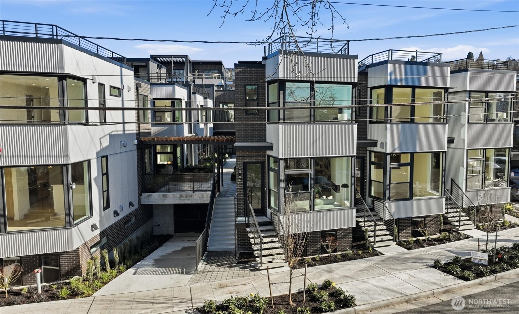 Set within the Harbor 26 community in the heart of Eastlake, this 3 bedroom home offers a well-balanced layout designed for comfortable, modern living. The open-concept main level connects kitchen, dining, and living spaces with clean lines, contemporary finishes, and an easy, functional flow that works for both daily life and entertaining. Large windows throughout the home frame city and Lake Union views, bringing in natural light and creating a constant connection to the surrounding landscape. The layout offers flexibility across multiple levels, ideal for guests, work-from-home setups, or additional living space, while the primary suite provides a calm, well-appointed retreat with a thoughtfully designed bath. Above, a private rooftop deck elevates the experience even further, capturing sweeping panoramic views of Lake Union and the Seattle skyline—perfect for unwinding or hosting. Located in a gated community just steps from the shoreline, this home includes a dedicated parking stall in the secured common garage, delivering convenience alongside design. Built by DEP Homes Eastlake, known for quality craftsmanship and intentional living. **Preferred lender rate buydown, 1% off todays current rates + lender credit to cover buyer closing costs & no fees on future refinance**