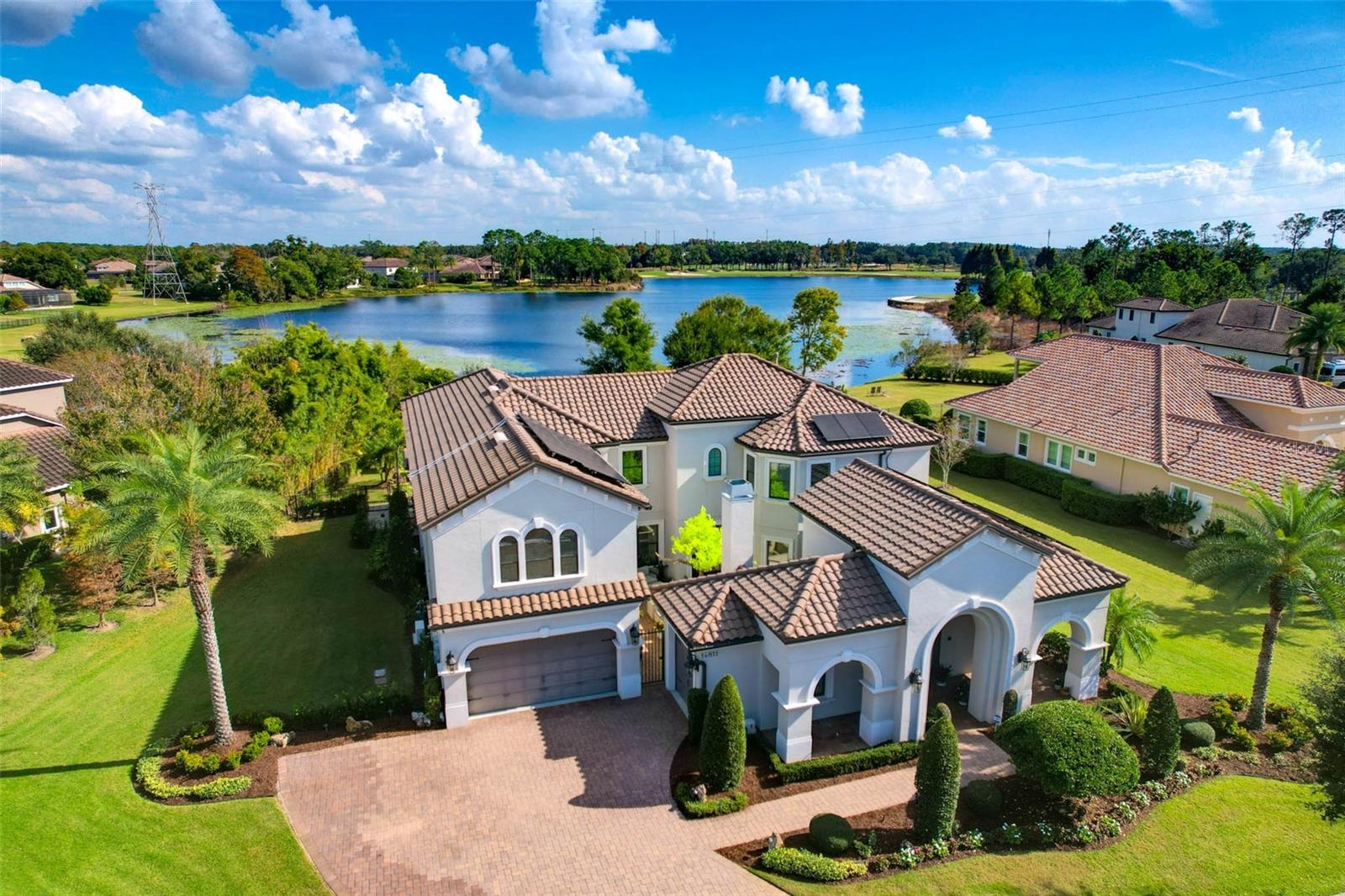 Discover elevated luxury living in the heart of the gated community of Old Memorial Estates. This exquisitely crafted residence showcases custom millwork throughout the home. Enjoy cozy time with family in the conservatory or a grand affair in the great room just to the other side with vaulted ceilings, grand windows with views to Hixon Lake and distant views of Old Memorial Golf Course. The primary suite is on the first level with the most amazing primary bath. Recently updated, you will feel like you are in a five-star hotel. Guests visiting for an extended time can come and go as they please with the en-suite guest bedroom with access from outside. The second level offers three bedrooms, two with en-suite baths, the game room and theater room waiting for its customization. As the interior of the home will take your breath away, the outdoors will provide you with a resort-style experience with the custom pool with fire and waterfall features. Feel like you are cave diving with the grotto feature in the pool. Enjoy the outdoors bug free with the mosquito system in place for those cozy fall nights outside by the fire pit. This is more than a home, it's a lifestyle of uncompromising excellence, just minutes from shopping, restaurants, Tampa International Airport and local beaches.