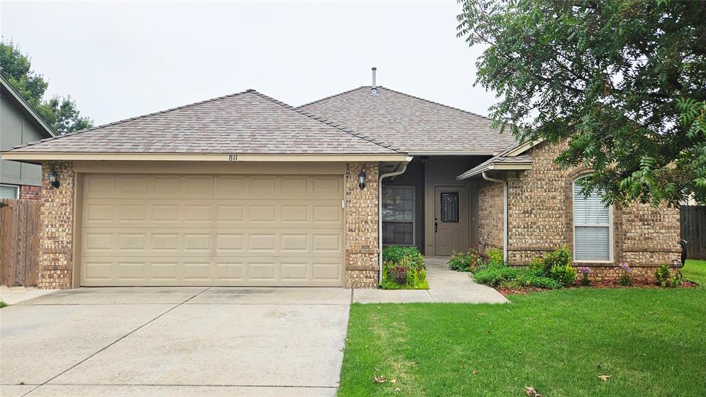 You don't want to miss out on this! Freshly repainted from top to bottom, this home offers a welcoming layout that flows from the living room to the dining area, kitchen, and beyond. The living room features a gas fireplace and high ceilings. The dining area includes built-in seating and a picture window overlooking the backyard. The kitchen comes equipped with a refrigerator, stove, and dishwasher. The spacious primary suite offers a walk-in closet and a large bathroom with dual sinks. Two additional bedrooms are nicely sized and share a full bath. A dedicated laundry room includes a washer and dryer for added convenience. The garage includes an in-floor storm shelter. Outside, the backyard features a producing vegetable garden, while the front walkway is lined with mint, herbs, and flowering plants, creating an inviting entryway. The home is also located very close to beautiful walking trails and a park, making it easy to enjoy the outdoors. Schedule your showing today!