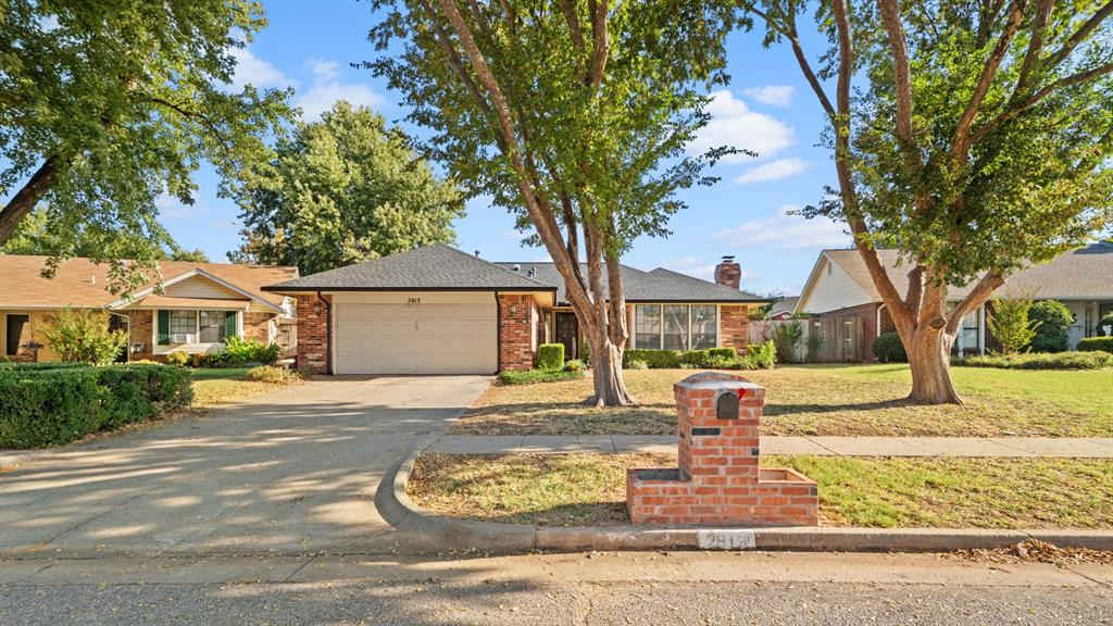 Move-in ready with room to personalize in a prime Edmond location just off W 15th & S Santa Fe. You’re just minutes to Mitch Park, Topgolf, Chisholm Creek, the elementary school, less than a 1 mile to Edmond Santa Fe High School, and within roughly 3 miles to both the Kilpatrick Turnpike and the Broadway Extension for easy OKC/Edmond access. The home is over 1,750 sq ft with classic red-brick curb appeal, a 2-year-old roof and gutters, and a large fenced backyard with an open patio. Inside, is a large living room (approx. 16' x 21') that features 9' ceilings, lots of natural light,  a matching red-brick fireplace, and solid wood built-ins on either side that anchor the fireplace nicely. A traditional defined kitchen and dining area flow nicely into a large sunroom, approx. 12' x 24' (which is not included in the listed sq ft). It also has a dedicated laundry room. The bedrooms are nicely sized with the primary bedroom measuring 14' x 15'9" with a walk-in closet, en suite and additional closet space in the room. Bedroom #2 is approx. 10'7" x 12'2", and bedroom #3 coming in at 11'5" x 12'2". This one is a really great opportunity with tons of potential. Don't miss out. Schedule your private showing today!