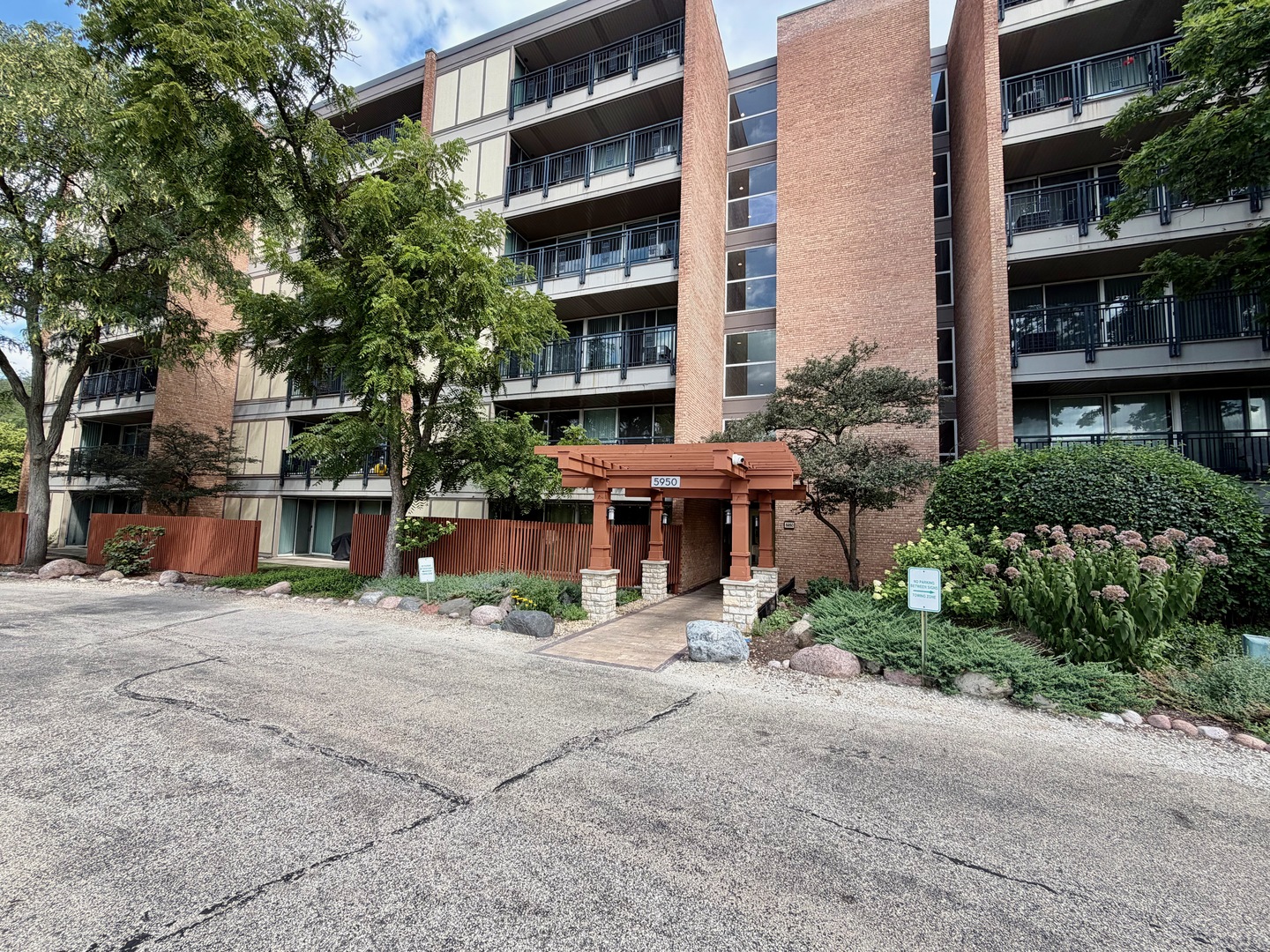 Wonderful Lisle location! This spacious 2-bedroom, 1.5-bath end unit offers breathtaking panoramic forest views and an abundance of natural light. The inviting living room features a striking brick accent wall and opens to a large private balcony overlooking the scenic surroundings. The second bedroom also enjoys its own private door to the balcony. There are Two Assigned Parking Spaces included as well. UPDATES INCLUDE: New Gas Furnace 2024, Water Heater 2022. Located in a resort-style community with exceptional amenities, including swimming pool, clubhouse, ski hill, ponds, and an on-site restaurant/pub. A brand-new wood-burning fireplace WITH Upgraded Blower (most other units do not have) has just been installed, with the finishing touches currently being completed, creating an even warmer and more inviting living space. All appliances stay including full sized in unit washer and dryer. D37 & D36 is the assigned spots (in front closer to Oakwood Dr).