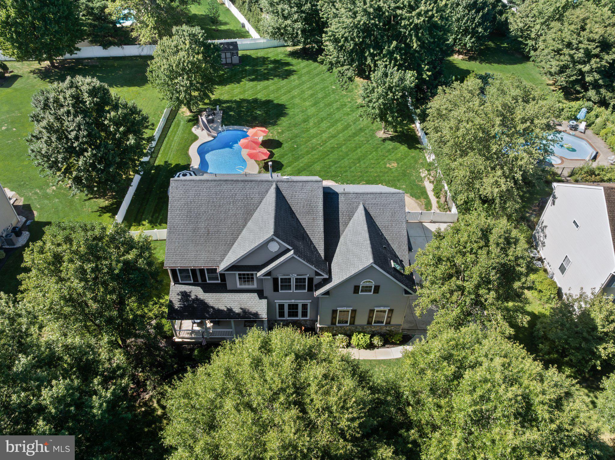 Welcome To This Exceptional 4 Bed, 3.5 Bath Brinton Model In Lumberton’s Highly Sought-After Coventry Glen, Where Timeless Style, Meticulous Care, Impressive Updates, And Resort-Inspired Outdoor Living Come Together On Just Over Half An Acre. From The Moment You Arrive, Beautiful Landscaping And A Charming Front Porch Create An Inviting First Impression. Step Inside To A Home That Is Truly Pristine—Freshly Painted Throughout, Flooded With Natural Light, And Impeccably Maintained. Gorgeous Refinished Hardwood Floors Extend Throughout Most Of The Main Level, While Extensive Millwork And Architectural Details Add Character And Sophistication. Just Off The Foyer, Double French Doors Open To A Private Home Office. The Spacious Formal Living Room Offers Hardwood Flooring And Classic Wainscoting And Flows Seamlessly Into The Elegant Dining Room, Creating The Perfect Backdrop For Memorable Gatherings. At The Heart Of The Home Is The Bright And Inviting Kitchen, Featuring A New (2025) Refrigerator, Stone Backsplash, White Washed Cabinetry, Convenient Pantry, Updated Lighting, And A Center Island With Seating. Best Of All, The Kitchen Opens Directly To An Expansive Covered Deck, Creating An Effortless Transition From Indoor Living To Your Very Own Backyard Retreat. And What A Retreat It Is! Overlooking The Sprawling Yard, The Oversized Deck Features Dual Ceiling Fans And Plenty Of Space For Outdoor Dining, Relaxing, And Entertaining. Step Down To The Paver Patio And Sparkling Inground Pool, And Suddenly Every Summer Day Feels Like A Staycation. The Gorgeous Concrete Liner Pool (2017) Features A Slide And A Built-In Inground Cleaning System For Minimal Maintenance, While The Expansive Lawn Still Leaves Plenty Of Room To Play, Entertain, Garden, Or Simply Enjoy The Privacy And Open Space. Back Inside, The Impressive Family Room Sits Just Off The Kitchen, Offering The Perfect Place To Unwind, With A Dramatic Vaulted Ceiling, Cozy Gas Fireplace, And Convenient Rear Staircase Providing A Second Route To The Upper Level. Rounding Out The Main Floor Is A Half Bath And Laundry Room/Mudroom. Upstairs, Elegant Double Doors Introduce The Luxurious Primary Suite—A True Private Sanctuary Featuring A Spacious Sitting Area And Two Large Walk-In Closets. The Spectacular Primary Bath, Beautifully Renovated In 2023, Delivers A Spa-Like Experience With Heated Floors, A Skylight, Two Floating Vanities With LED Mirrors, And A Stunning Glass-Enclosed Stone And Tile Shower. Down The Hall You Will Find A Full Bath Featuring Dual Sinks, Three Additional Generously Sized Bedrooms, Including One With A Walk-In Closet, As Well As A Convenient Tech Center/Office Nook On The Upper Landing, Adding Even More Versatility. The Finished Walkout Basement Takes This Home To Another Level, Offering An Incredible Extension Of The Living Space With A Full Bathroom, Wet Bar, And Abundant Room For Entertaining, As Well As A Massive Amount Of Unfinished Storage Space. With Direct Access To The Backyard, It's Perfectly Positioned For Poolside Entertaining And Effortless Indoor/Outdoor Gatherings. Additional Highlights Include A Newer Roof (2017), Newer Dual Zoned HVAC System And Hot Water Heater (2020), A Side Entry 2-Car Garage Equipped With A 240volt, 48amp Tesla Charger, And So Much More. Pristine, Spacious, Beautifully Updated, And Made For Entertaining, This Exceptional Coventry Glen Home Offers The Complete Package—Impressive Interiors, Flexible Living Space, A Luxurious Primary Retreat, And An Unforgettable Backyard Oasis. This Is More Than A Beautiful Home—It’s The Lifestyle You’ve Been Waiting For.