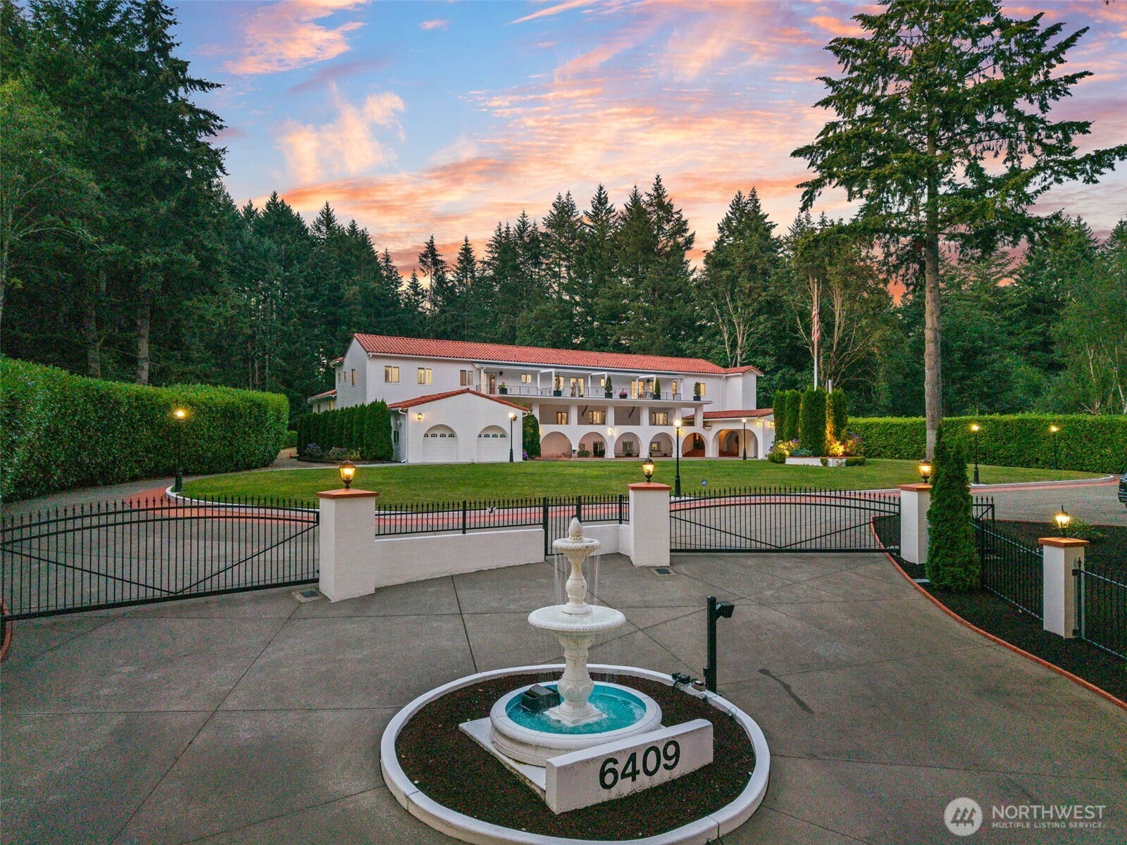 A truly extraordinary Spanish-inspired estate, distinguished by its timeless white stucco exterior, red tile roof, and exceptional craftsmanship. Beyond the secure gated entry, immaculate grounds and a grand circular drive set the stage for an unforgettable arrival. Inside, marble floors, sparkling crystal chandeliers, soaring ceilings, and exquisite finishes create an atmosphere of refined luxury, enhanced by an integrated sound system, video security, elevator access to both levels, and a temperature-controlled wine cellar.    Designed for grand-scale living and entertaining, the main residence offers 7 bedrooms and 9 baths, including a private ADU off the lower level, plus a detached casita, pool house, and outdoor kitchen in the courtyard totalling 14K sf! The chef's kitchen is a masterpiece with 4 sinks, gas range, double ovens, and a pass-through bar with heat lamps. The elegant dining room seats 20. Relax in the den featuring a full bar and second kitchen.    Resort-style amenities include a spectacular indoor pool house with heated pools, a jacuzzi, two bathrooms, and poolside shower, along with an outdoor kitchen equipped with professional-grade appliances, inviting courtyard fire pit, and multiple seating areas. An additional 2 acres of undeveloped land. Close to hospitals, dining, and shopping! This home has even served as a filming location for the movie "Last Seen in Idaho." Be sure to watch the property video. Rare opportunity to own a truly private mansion.