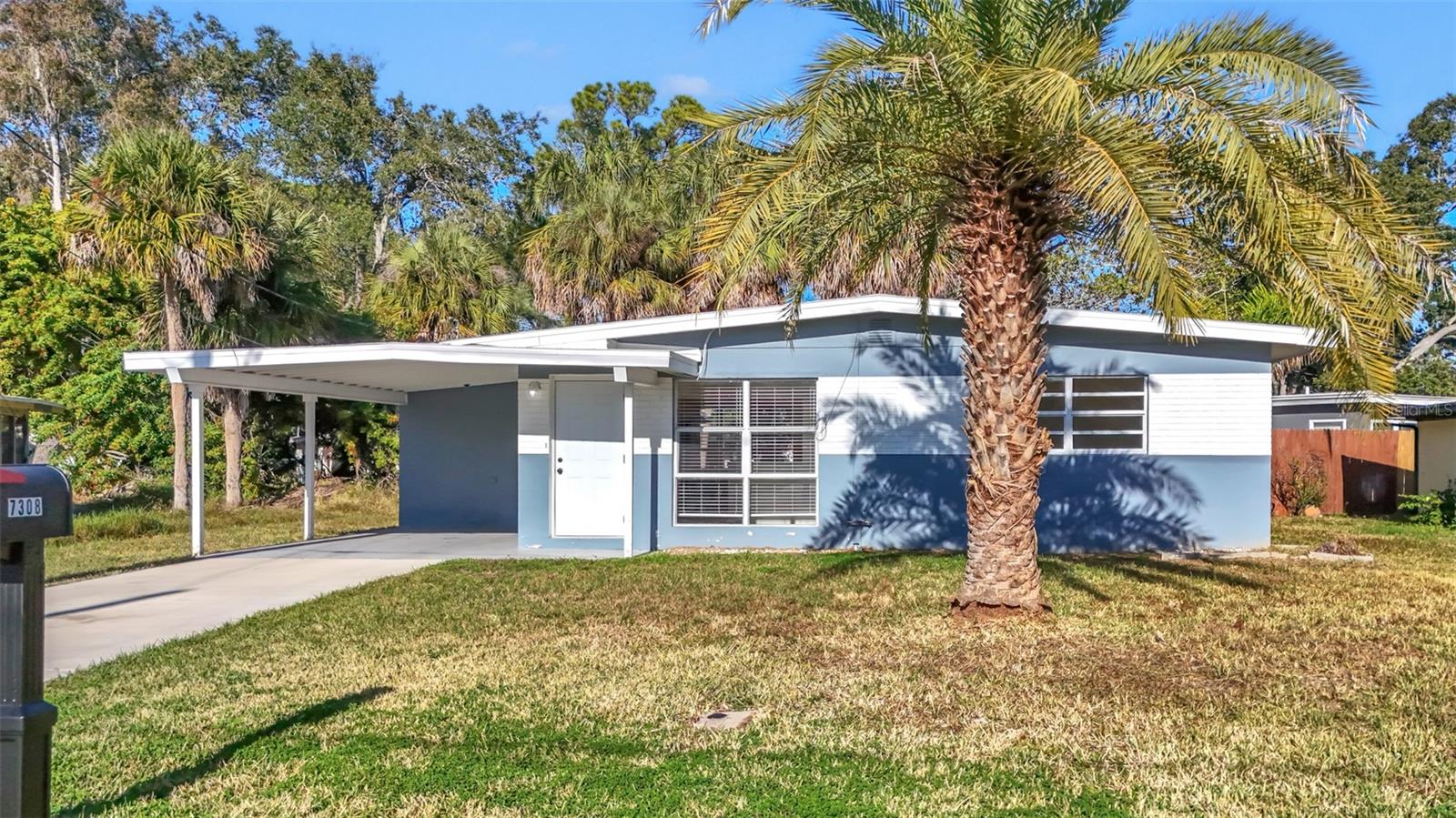 Welcome to this spacious two-bedroom, one-bath home located in the Jasmine Acres Community.  This renovated home features an open floor plan with large windows that provide plenty of natural light. This home has terrazzo flooring throughout (replaced in 2023), updated light fixtures, ceiling fans, and window treatments.The fully remodeled kitchen showcases stone countertops, beautiful wooden cabinetry, and  stainless steel appliances.  A convenient laundry room comes complete with a washer and dryer and offers generous storage space. The carport easily fits two vehicles and the covered rear patio provides an outside space to relax or entertain year-round. Electrical, plumbing and water heater have all been recently updated. Jasmine Point Estates is a great community with NO HOA and is close to parks, a variety of restaurants, shopping, Urban Air Trampoline and Adventure Park, and Walmart Supercenter. Enjoy easy access to state parks, nature reserves, and marinas, with downtown New Port Richey, waterfront restaurants, bars, shops, and major highways nearby. Best of all, it’s just a short drive to the beautiful West Coast beaches.