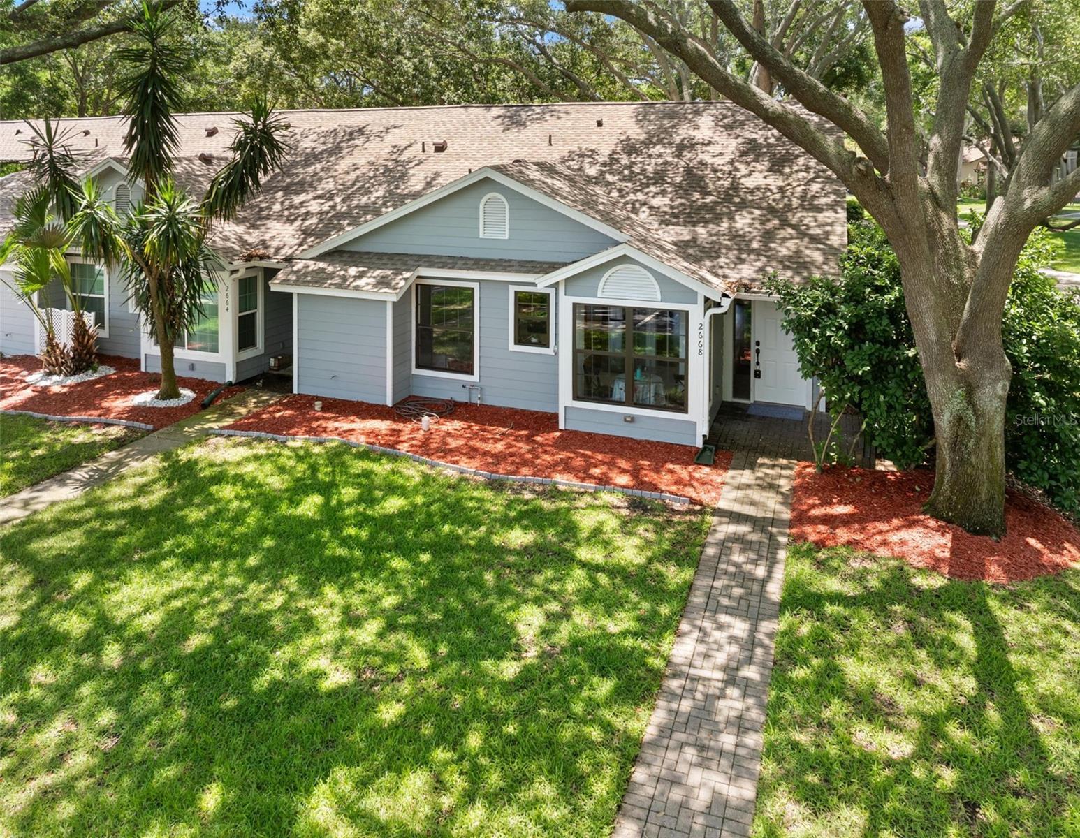 Location, Location, Location and pet friendly. Spacious and inviting 2-bedroom 2-bath villa located in the highly desirable community of Palm Harbor! This stunning large end unit,  well designed home offers an open and comfortable layout with generous living space, abundant natural light, and a functional floor plan perfect for everyday living or seasonal enjoyment. The roomy primary suite features a private full bath while the second bedroom is Roomy. Large closed in Screen porch is a sanctuary for private relaxation. Nice on premise inside storage. Top desirable schools Highland Lakes Elementary, Carwise Middle and Palm Harbor University High. Pool and Tennis courts. 2 assigned parking spaces one is a large carport.Enjoy the low maintenance free living in a beautifully kept neighborhood with attractive surroundings with convenient access to Publix shopping, dinning, beaches parks, top-rated amenities pool and tennis courts. Home Owners Association includes water. sewer and cable.Freshly painted, Roof 2024, AC  2011 , water heater 2026 . A wonderful opportunity to enjoy Florida lifestyle in a great location.