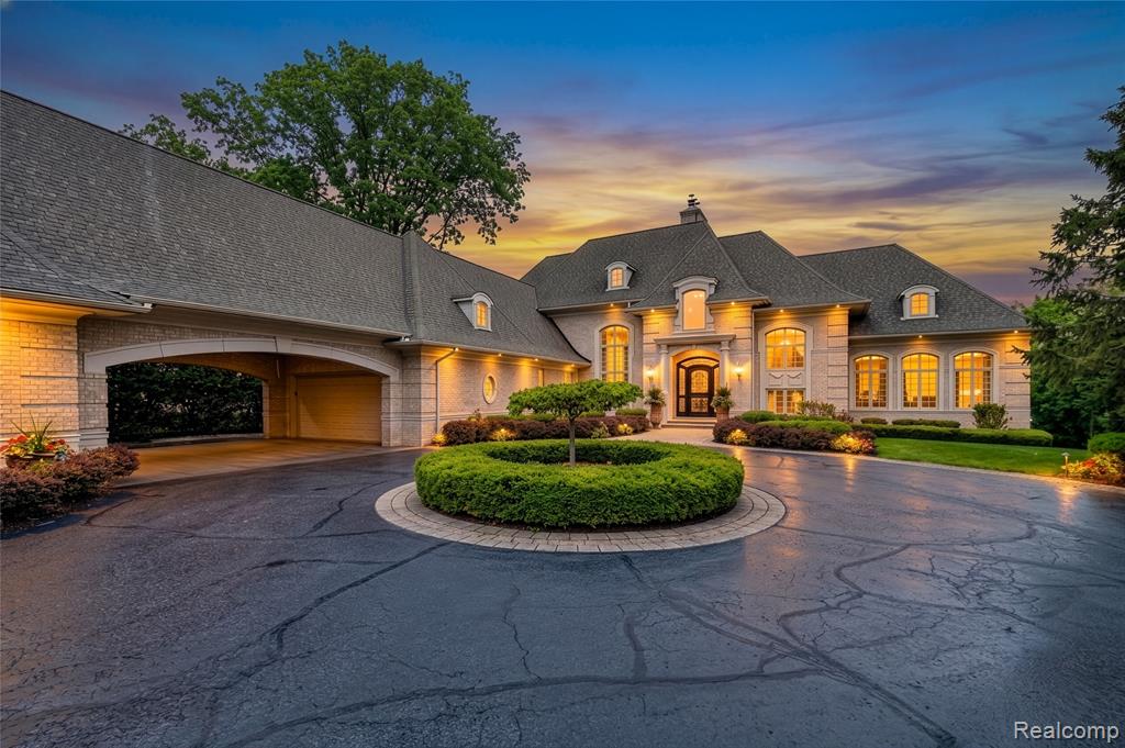 This lovely 2008-built French Provincial home sits on the western side of Wing Lake. The long circular driveway, porte cochere, and four car garage create a stunning scene as you arrive. Built with quality materials throughout, the home offers many areas for entertaining large groups or simply relaxing on one of several terraces while looking at the lake.  There is a first-floor primary suite, large family room connected to the kitchen, formal living and dining rooms, and a wood-paneled den, all with views of the lake. An In-laws suite is also on the first floor, along with a large laundry room. The second floor has three more bedrooms and two full baths.  One of the baths connects two bedrooms. The finished walk-out basement adds another 3088 sq ft of living space, great access to the patio and lakefront, a workout room, a computer room, small kitchen, and more.  The location of the home makes it easy to commute to work, then come home to a peaceful spot on a lovely lake.  Whole house generator. Four car garage.  Large closet on all three levels is ready for an elevator to be added. Private terraces off the kitchen, dining room, primary suite, den, and lower level. Views of the lake from most rooms in the house. Very lightly lived-in, this home is immaculate. There is a lot to see and enjoy!