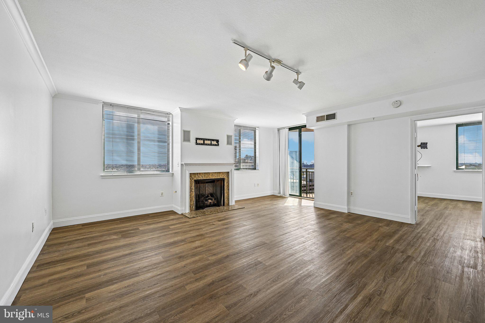 Nestled in the vibrant Inner Harbor community, this stunning 3-bedroom, 2.5-bathroom apartment offers a perfect blend of modern living and urban convenience. With 1,403 square feet of thoughtfully designed space, this contemporary unit is ideal for those seeking a comfortable and stylish home. Step inside to discover an inviting atmosphere enhanced by beautiful new wood flooring and an abundance of natural light. The spacious living area features a cozy gas fireplace and access to a private balcony with breathtaking city views. The kitchen is equipped with sleek stainless steel appliances and ample counter space and cabinetry. In the hall adjacent to the kitchen is a powder room and a convenient in-unit washer and dryer. Retreat to the luxurious master suite, complete with a walk-in closet and an en-suite bathroom featuring a soaking tub and a walk-in shower. The second bedroom off the living room is also complete with an en-suite bathroom featuring a walk-in shower. The third bedroom off the entry and hallway could be an excellent home office or den. The beautiful building offers a range of amenities, including a lobby concierge, a community pool, fitness center, party/recreation room, a business center, and a covered parking garage. This location is unbeatable. Enjoy walkability and easy access to downtown attractions and proximity to the city's major academic and medical institutions.