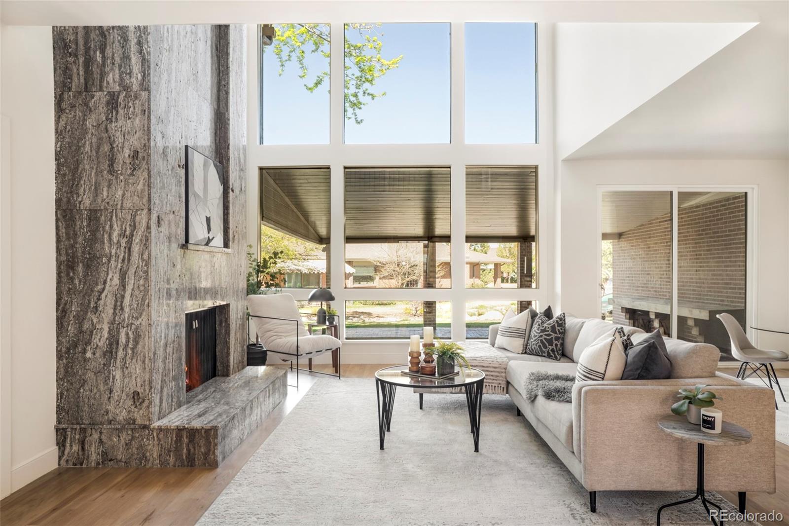 Beautiful, completely renovated townhome in the prestigious "Cherry Hills III" gated community. Nested on an interior lot overlooking the tranquil stream; your own private sanctuary. Step into an open, inviting floorplan. The stunning great room features a high ceiling, full wall of windows, abundant natural light and expansive views; 2 story stone fireplace, custom dry bar and informal dining space with doors opening to lovely brick patio. The gorgeous kitchen offers custom cabinetry, Bellagio stone counters, gleaming brass hardware, Kohler fixtures, gorgeous tile work and new lighting. Monogram 42" built-in refrigerator and 36" gas range, pot filler, custom plaster hood, built-in microwave and dishwasher. Formal dining room opens to private brick patio. Reimagined main floor layout boasts a new primary suite with stone surround fireplace and doors to private patio; freestanding tub & double walk-in shower, double vanity, huge walk-in closet with laundry hookup. Second primary suite upstairs has large balcony with amazing view, en suite bath has double walk-in shower with rain head, double vanity, walk-in closet & laundry hookup. 2 additional bedrooms plus full bath upstairs. Basement features family room with fireplace, gorgeous wet bar, conforming bedroom with adjacent bath, glass enclosed gym, hydration station, tiled laundry room, wine storage plus flex space. This amazing showpiece is professionally designed using the finest quality fixtures and custom finishes. The extensive remodel boasts a custom steel & glass front door, 2 new HVAC systems, tankless water heater, new windows and doors, custom steel railings, new electrical, plumbing, newly poured concrete patio with brick & gas line for grill. Refinished oak flooring, new vinyl flooring and carpeting. Cherry Hills III offers a 24 hr staffed entry, outdoor pool, year round hot tub, sauna, tennis & pickle ball courts, clubhouse plus social activities. Visit this beautiful showplace, you wont be disappointed!